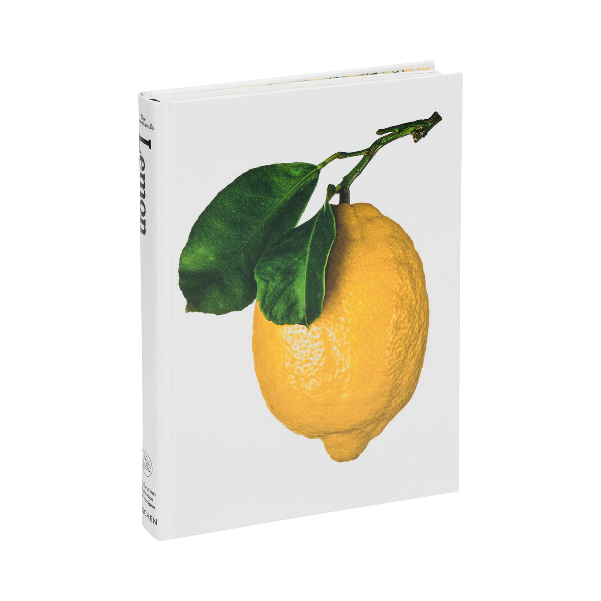 A white coffee table book featuring a high-quality graphic print of a bright yellow lemon with two green leaves on a stem, shown against a plain white background.