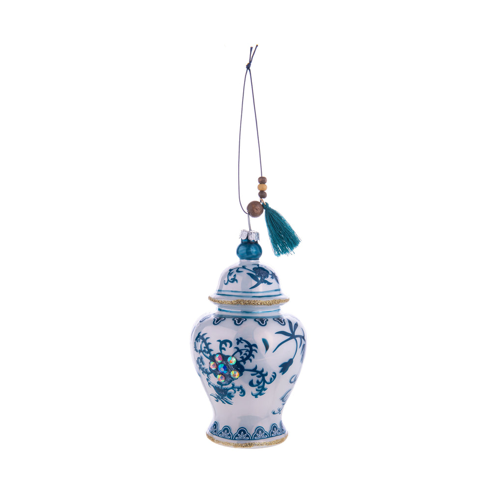 With its intricate blue and white patterns, this Ginger Jar glass ornament is charming and inspired by vintage chinoiserie jars. Decorated with gold glitter and rhinestones, this ginger jar will elevate your home and holiday decor. Comes with ribbon for hanging. Dimensions: Approx. 4.5" H x 2.5" W Glass ornament