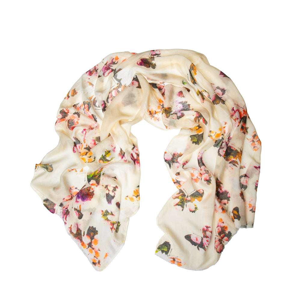 This light, gauzy scarf is made from a super-soft blend of modal and linen, making it a great scarf to throw into your purse for a quick, chic beach cover up, or to wrap around your shoulders as the sun goes down. The cream base is decorated with rose-patterned butterflies. Material: 85% modal. 15% linen. 30" x 74".