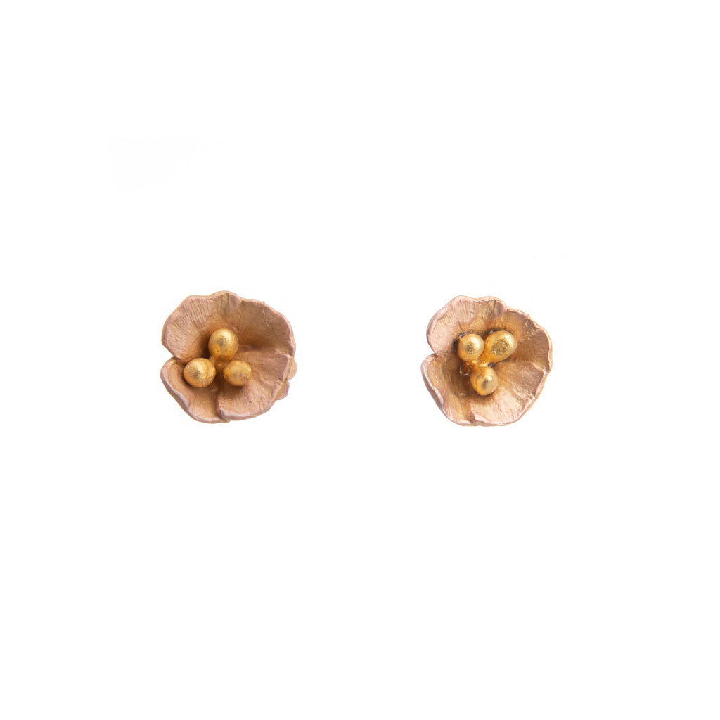 These elegant poppy stud earrings are perfect to wear every day or for special occasions, with just the right amount of detail and a gorgeous golden glow. Materials: hand-finished cast bronze with 24K gold-plated petals and cast-bronze pollen stems Silver posts Dimensions: 0.5" x 0.5"