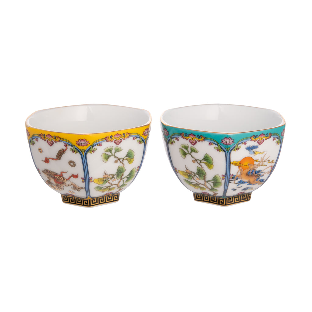 In a hexagon shape, these traditional sipper tea cups are adorned with images of deer, ginkgo leaves, koi, and more. With gold edges and floral detail surrounding the paneled images. Perfect for a tea date. Set of two, one yellow cup & one blue cup Dimensions: approx. 2.5" x 3.5" Material: Ceramic