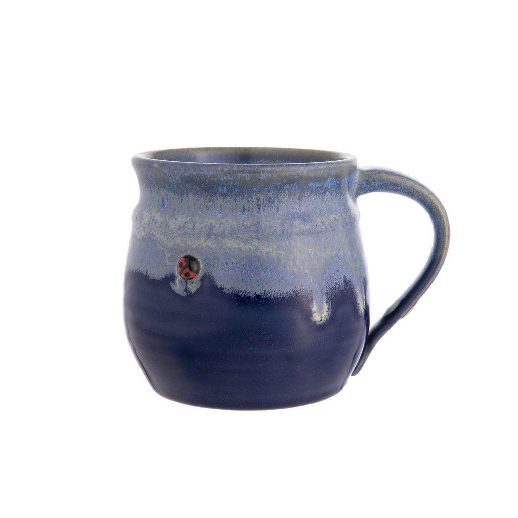 This delightful stoneware mug is made entirely by hand. Each mug is thrown on a potter’s wheel, and a cute clay ladybug is added before the mug is fired and hand glazed. Material: stoneware clay 100% handmade Dimensions: 4" x 3.25" Holds approximately 12 oz. Microwave and dishwasher safe.