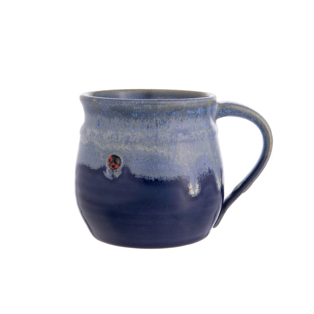 This ladybug stoneware mug is adorable and made entirely by hand. Each mug is thrown on a potter’s wheel, and a cute clay ladybug is added before the mug is fired and hand glazed. Please note: Since the mug is handmade, each one will be slightly different than pictured. 4.5" x 5.5". Microwave and dishwasher safe.