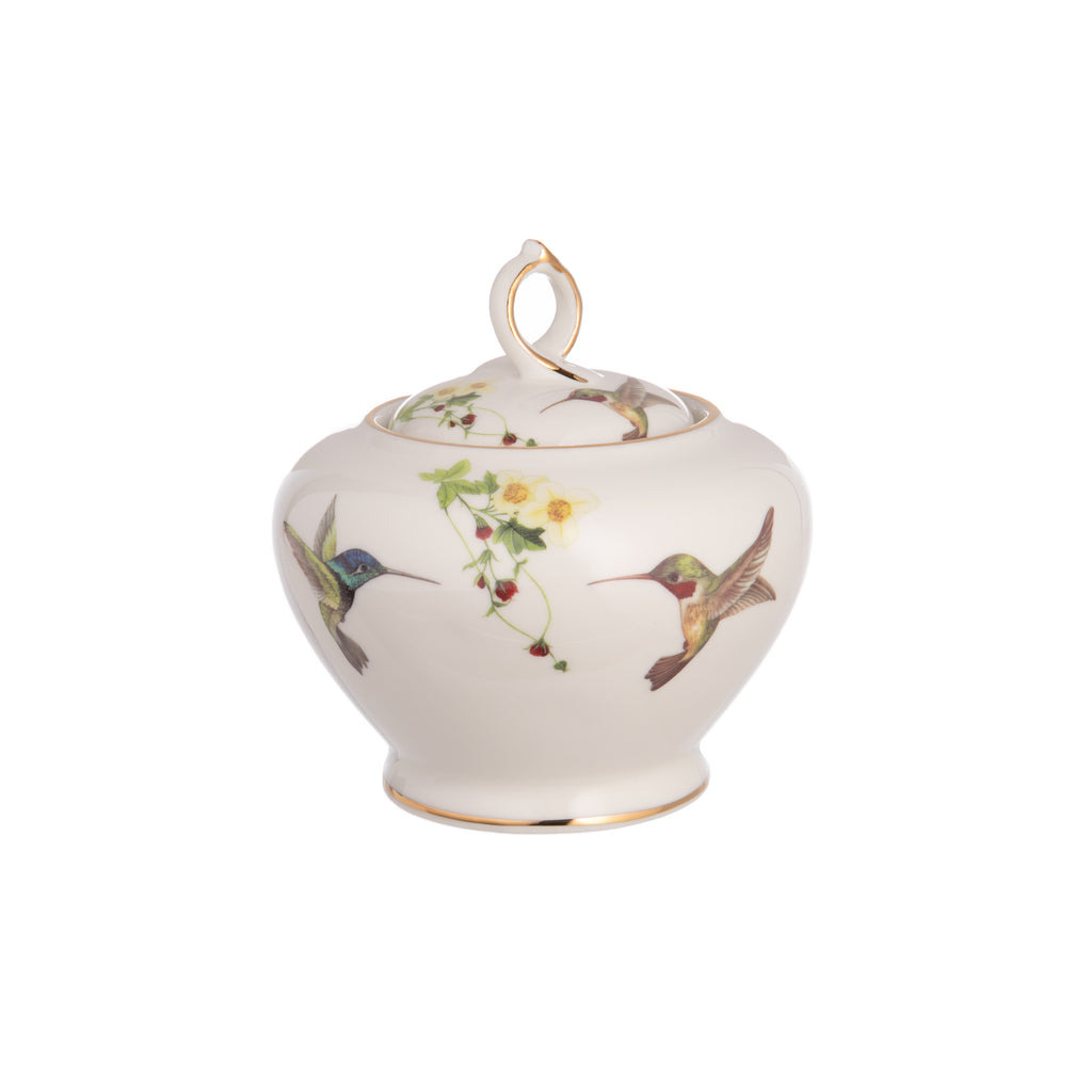 This delightful, lidded sugar bowl is made from fine bone China and is adorned with a charming hummingbird motif. It is finished with luxurious 10K gold accents, making it perfect for serving sugar alongside your coffee, tea and desserts. Material: Fine bone China Capacity 8 oz. Dimensions: 3.5" x 5.5".
