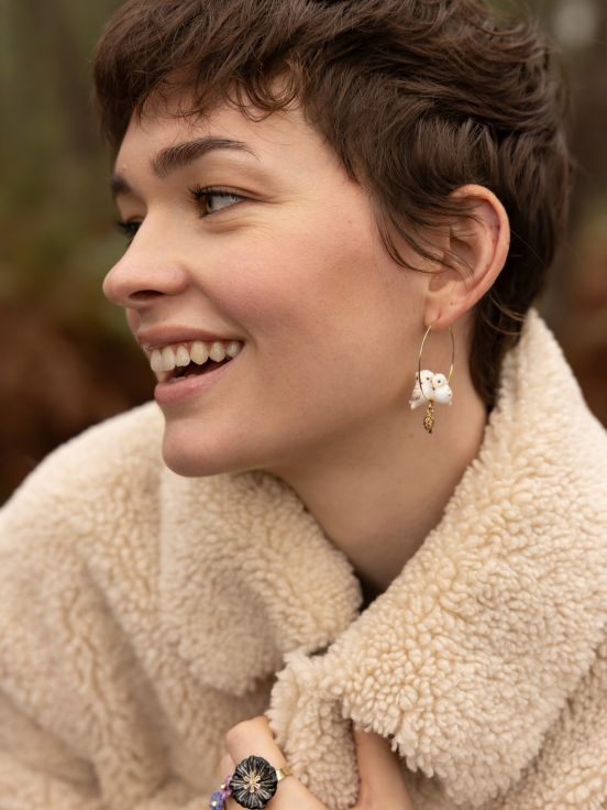 We love these cuddly owl besties on a delicate hoop! These gold-plated hoop earrings feature twin owls snuggled over a dangling gold leaf. On a delicate hoop, these earrings bring natural glam to any look. Lead and Nickel-free Material: Porcelain, Gold-plated Stainless Steel Designed in Toulouse, France.