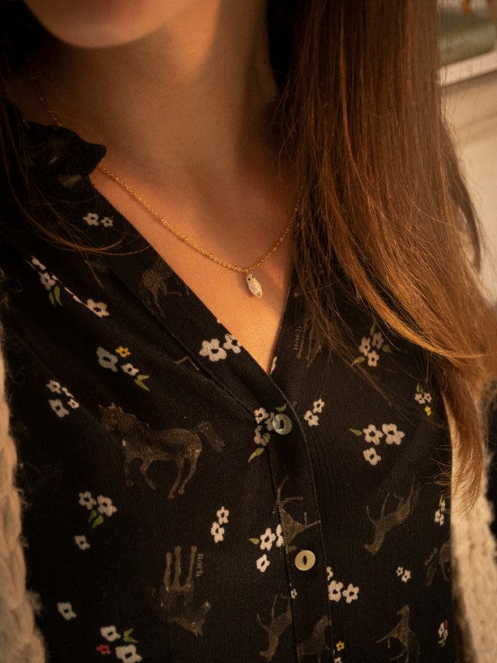 We love this teeny tiny owl featured on a gold chain necklace. Hand-painted with gold detail, this sweet little owl adds a delicate touch of nature to your outfit. This makes the perfect gift for any owl lover or bird watcher. Lead and Nickel-free Material: Porcelain, Gold-plated Brass Designed in Toulouse, France