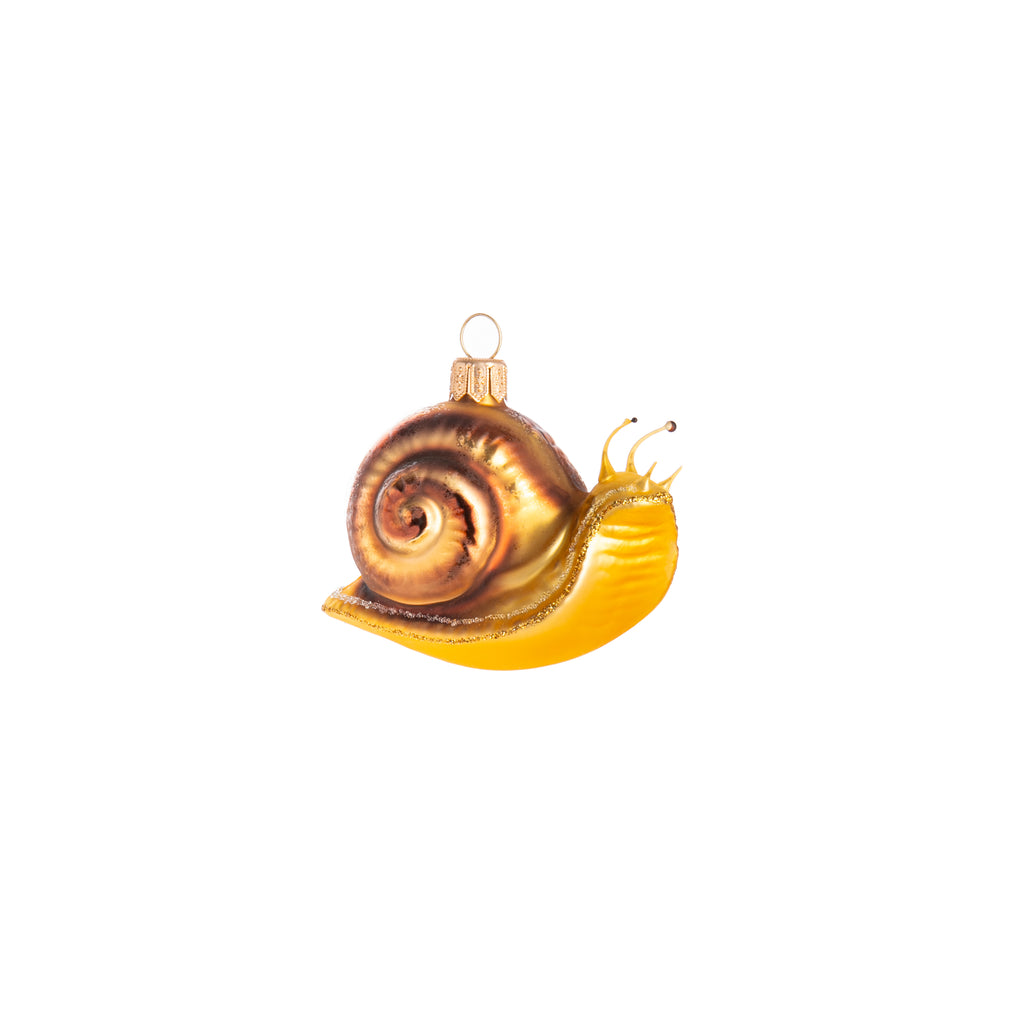 Take in the slow-paced life with this gorgeous glass snail ornament.   Comes in both gold and green, as well as glitter and frosted detail to add a little magic to these slow-moving bugs.  Glass ornament Dimensions: approx. 2" x 3" x 1.5"