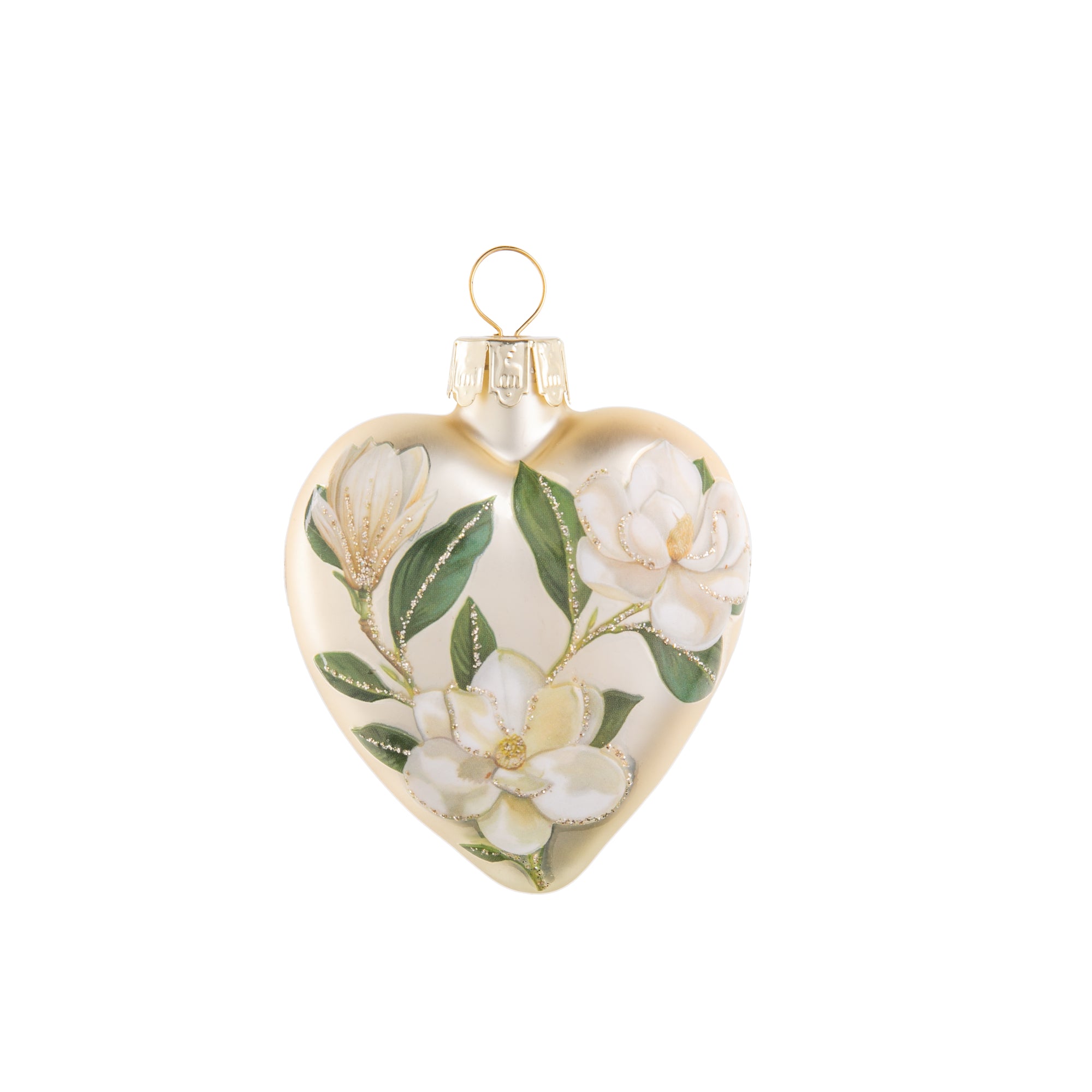 This delightful, vintage style, double sided glass heart-shaped ornament is adorned with a beautiful bouquet of magnificent magnolia flowers. Its pretty pastel tones, and glittered accents will add a hint of classic charm to your holiday decor. Glass ornament Hand glittered. Dimensions: 3" x 2.5" x 0.75".