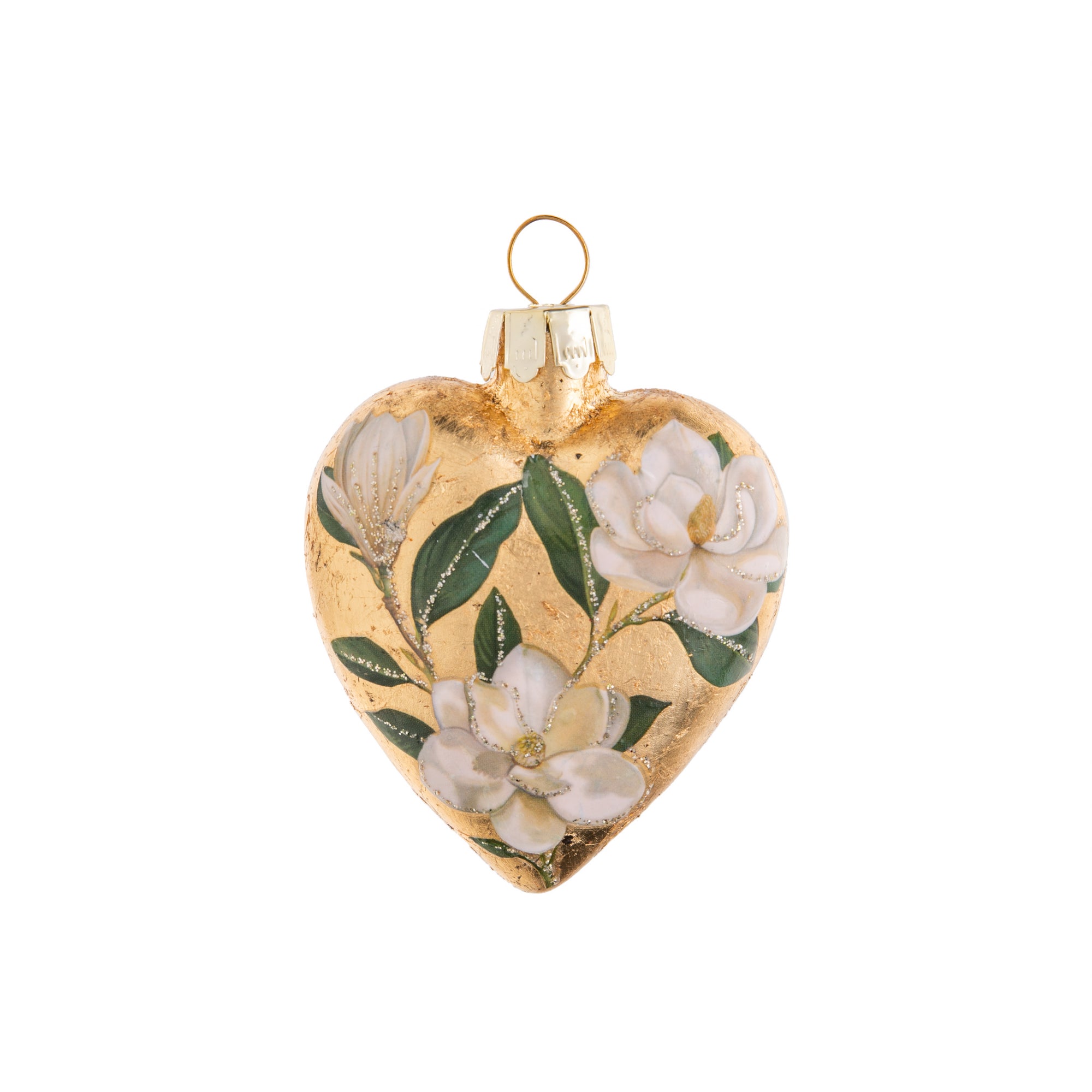 This delightful, vintage style, double sided glass heart-shaped ornament is adorned with a beautiful bouquet of magnificent magnolia flowers. Its pretty pastel tones, and glittered accents will add a hint of classic charm to your holiday decor. Glass ornament Hand glittered. Dimensions: 3" x 2.5" x 0.75".