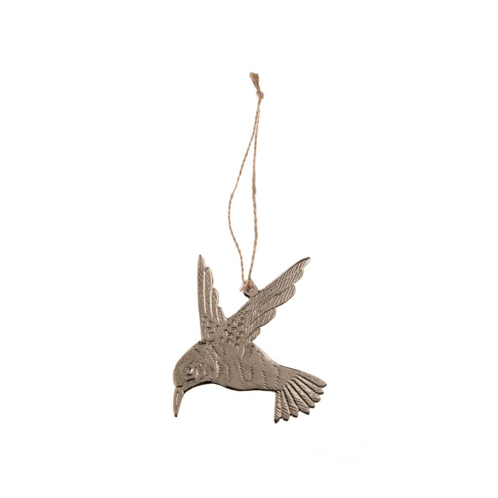 Capture the majestic nature of a hummingbird with this gold hummingbird ornament. In gold-plated metal, this hummingbird looks as if it is mid-flight and would look as astonishing as a real one -- whether on your holiday tree, near a window, or hung on the wall. Comes with rope for hanging. Dimensions: 4" x 4.5"