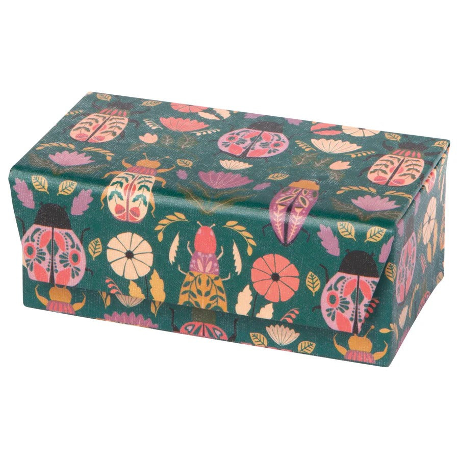 Keep your jewels protected with this Amulet Travel Jewelry Box! In emerald green, this case is adorned with scarab beetles. The inside has compartments for rings, earrings, and other small items.  Dimensions: 4.25" L x 2.5" D x 2" H Material: Box - 100% Recycled Cotton Paper, Lining - 100% Polyester Velvet 