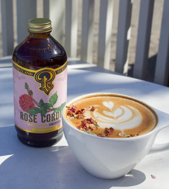 Fragrant, whole dried rose blossoms and petals are slow brewed in stages with dried rose hips. It is sweet and tart and is extremely versatile. The Rose Cordial is also delicious in coffee and tea. Hand-brewed in Oregon Ingredients: Water, Dried Rose Bud and Petals, Dried Rose Hip, Organic Cane Sugar, Citric Acid.