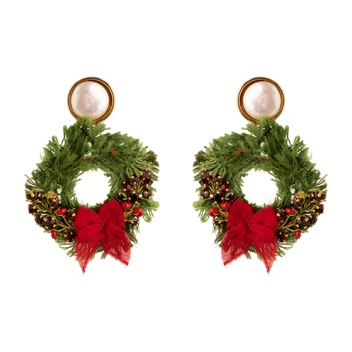 Pair of earrings shaped like Christmas wreaths with red bows on a white background