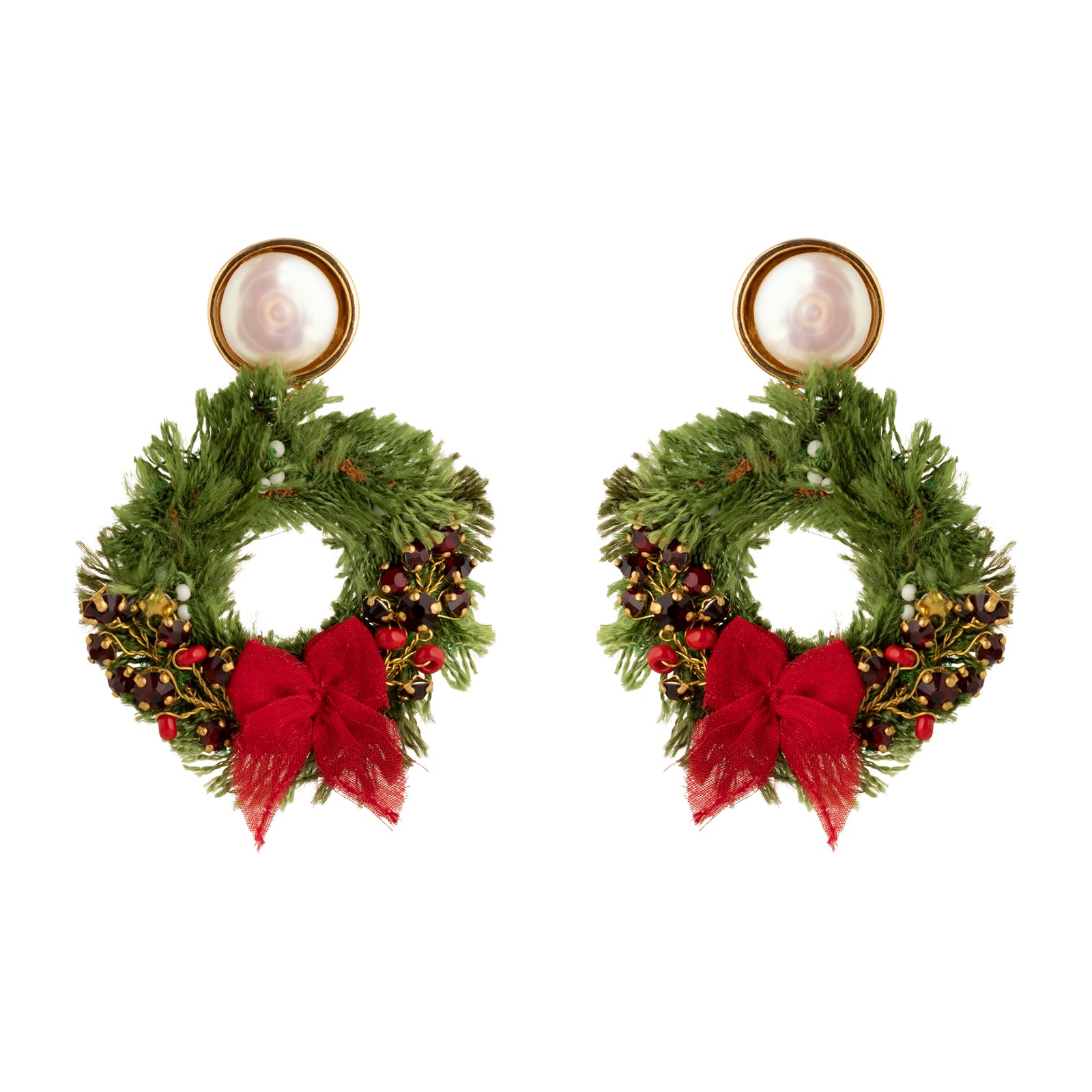 Pair of earrings shaped like Christmas wreaths with red bows on a white background