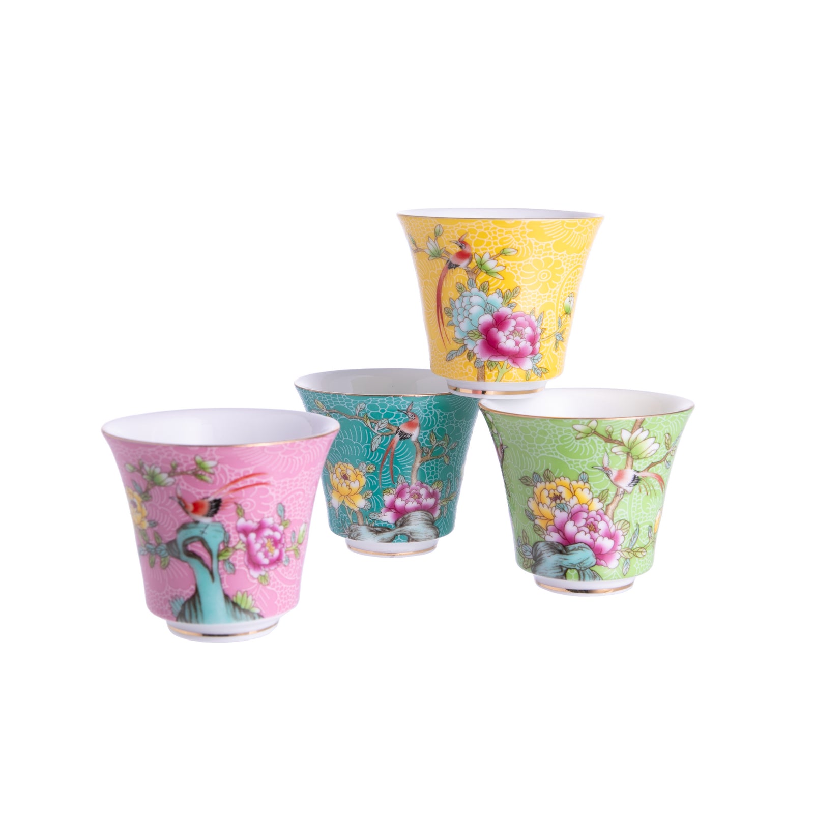 A set of four multicolored ceramic teacups with floral and bird patterns, displayed against a white background.