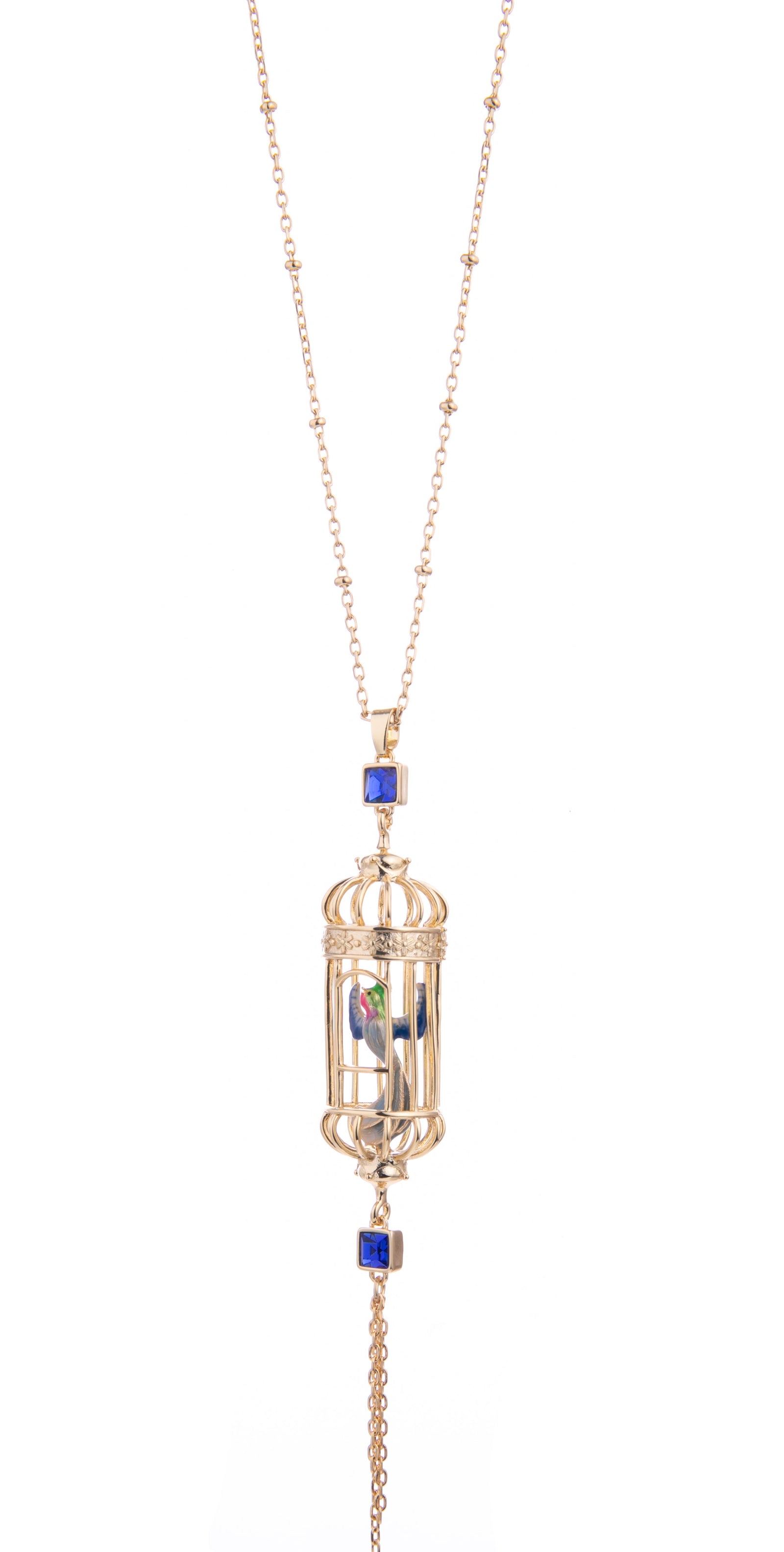 This bird cage drop pendant necklace evokes whimsy and elegance.  The hand-crafted enamel bird sits inside an intricate gold-plated cage. With an 18ct gold-plated bead chain with delicate gold tassels. Material: Gold-plated Brass, Enamel Dimensions: 13" Total Length.