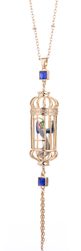 This bird cage drop pendant necklace evokes whimsy and elegance.  The hand-crafted enamel bird sits inside an intricate gold-plated cage. With an 18ct gold-plated bead chain with delicate gold tassels. Material: Gold-plated Brass, Enamel Dimensions: 13" Total Length.