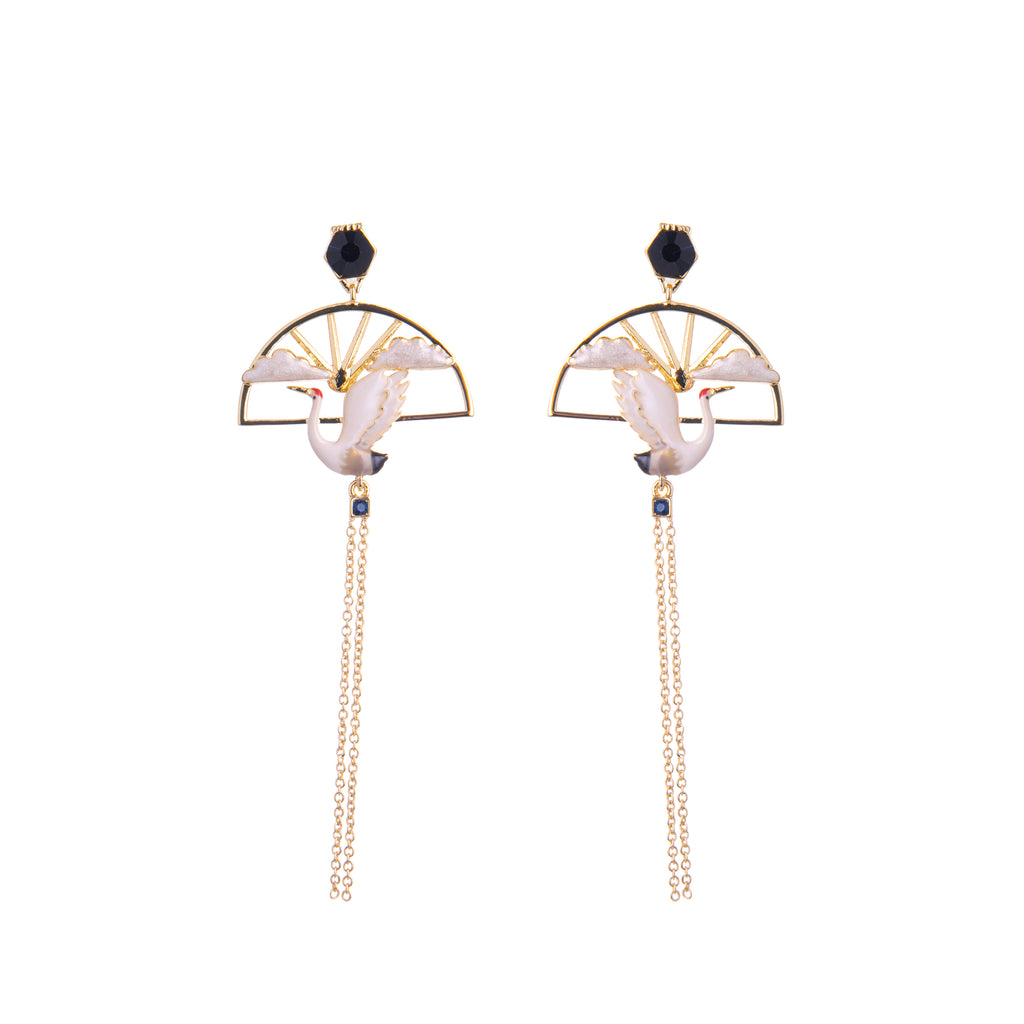 These Asian-inspired earrings feature a beautiful hand-painted crane and pearlized resin clouds set on a high polish 18ct gold plated sunray beneath a deep blue simulated sapphire stud. Materials: 18ct gold plated metal, enamel. Surgical steel posts. Dimensions: 2.75" x 1".