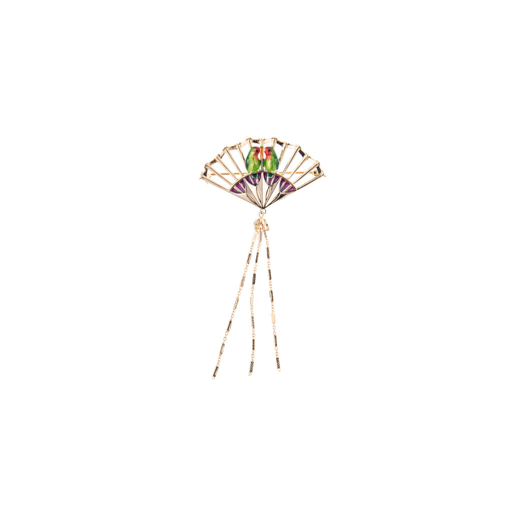 This Lovebirds on a Fan brooch is something to swoon over as the enamel birds in their bright colors make this brooch stand out. With an added level of golden detail and a dangling gold chain, this brooch will level up any outfit you wear with it. Material: Gold-plated Brass, Enamel Dimensions: Approx. 2" W x 3.5" L