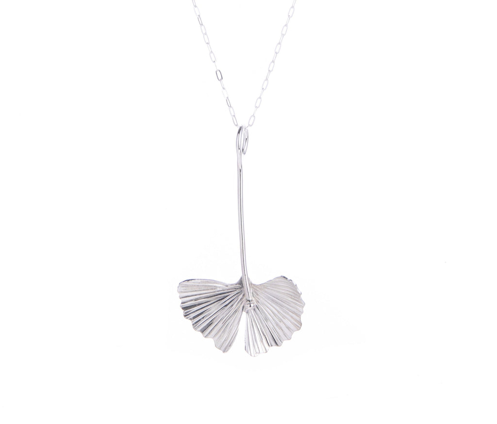 This sterling silver drop necklace features the ginkgo leaf. With a sterling silver chain, this handcrafted drop necklace will add botanical charm to any outfit. Would make a gorgeous gift for anyone looking to add ginkgo glam to their look. Handcrafted Material: Sterling Silver (.925) Dimensions: 1.5" x 1" x 0.5"