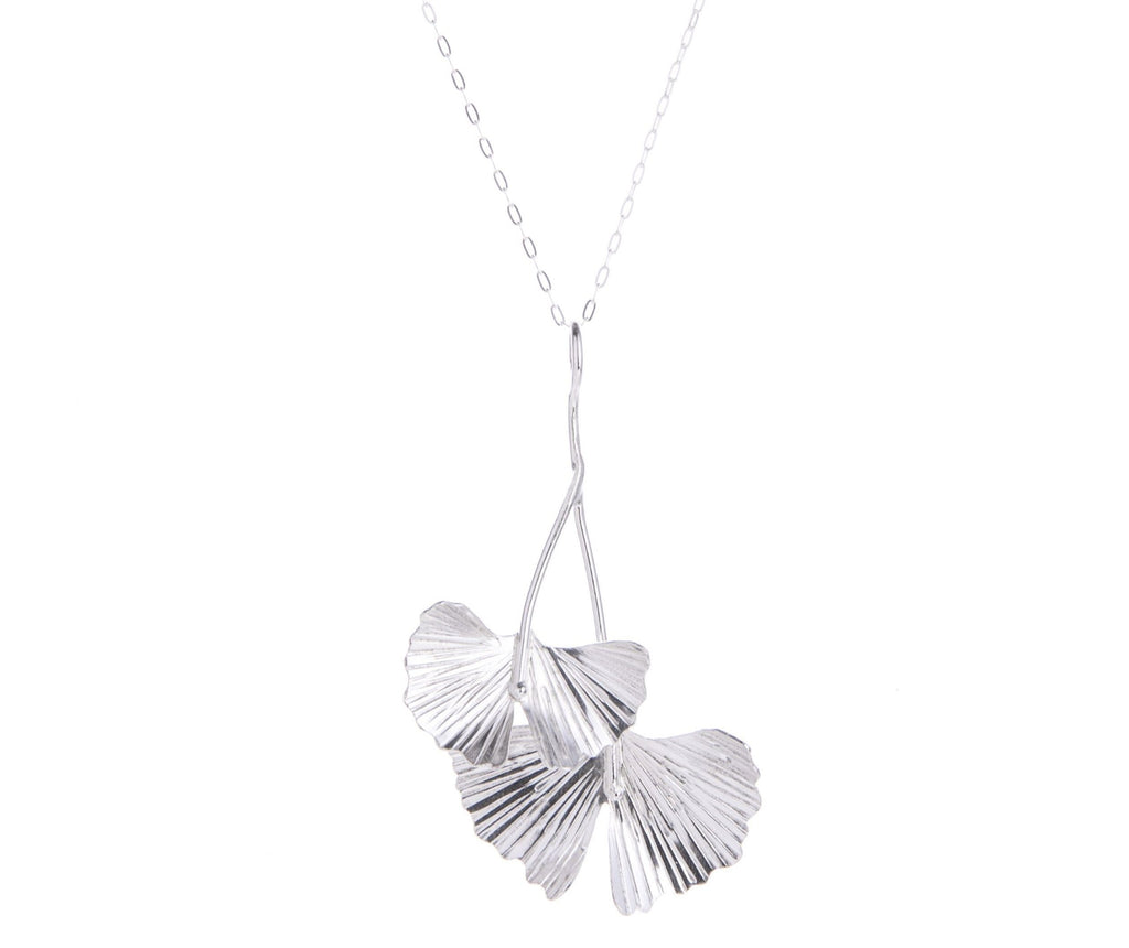 Celebrate the ginkgo tree with this sterling silver pendant necklace featuring ginkgo leaves. With a sterling silver chain, this handcrafted necklace will add botanical charm to any outfit. Would make a gorgeous gift. Handcrafted Material: Sterling Silver (.925) Dimensions: 4.0" x 2.5" x 0.5"