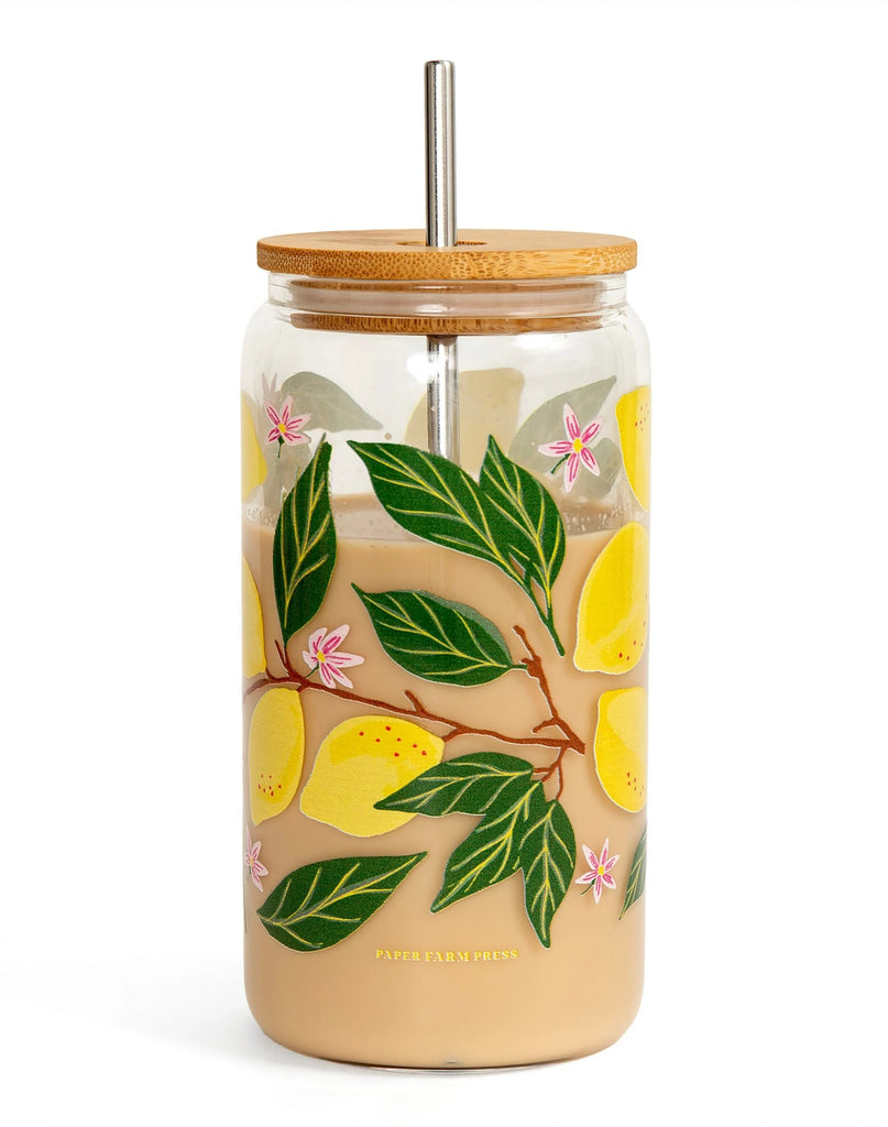 Take your beverage to go with this Lemon Grove Glass Can! This glass is perfect for your iced coffee or even your fresh-squeezed lemonade. Hand-painted design of a lemon grove with pink flowers. With a bamboo lid and metal straw.  Holds 16 oz. Dimensions: approx. 6" H x 3" D Care instructions: Hand wash only