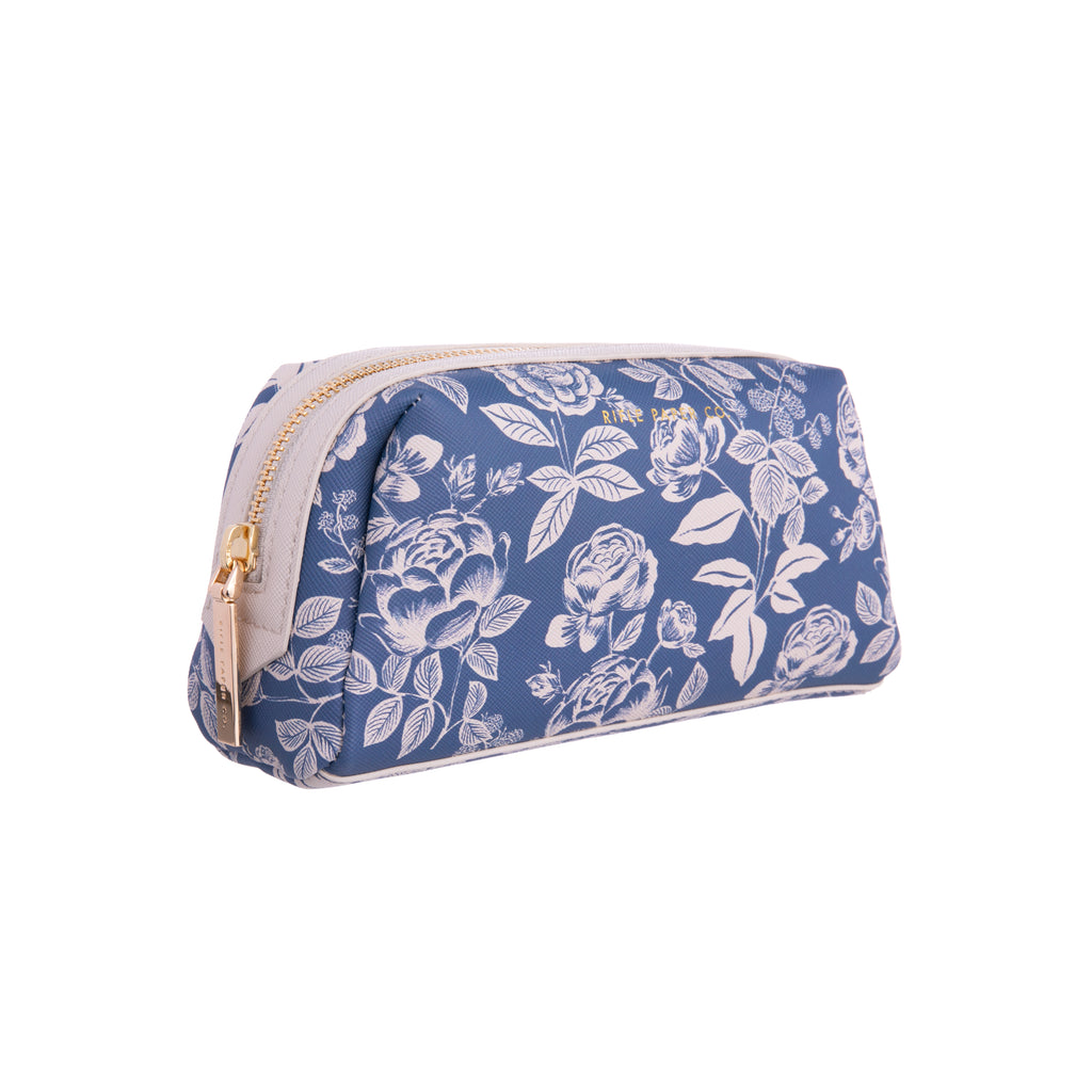 Tuck away cosmetics, toiletries, or brushes at home or while you travel in this delightful English Rose small cosmetic pouch. The blue and white pattern is reminiscent of classic Delft ware pottery, giving this pretty purse a subtle and chic vintage look. Gold zipper and hardware Wipe-clean lining 4.25" × 7" × 2.5".