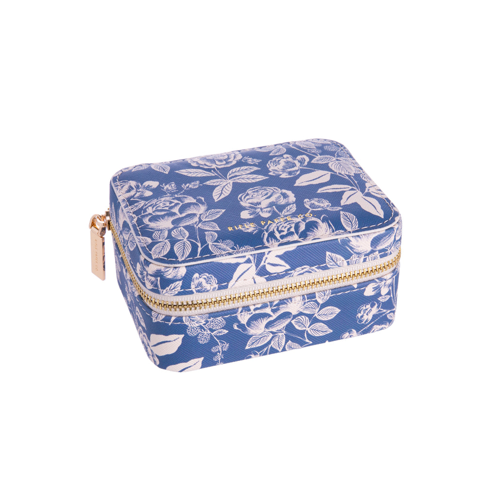 Keep your jewels safe and protected with this English Rose travel jewelry case! In a muted blue with white roses, this jewelry case is stylish and efficient. With a zipper and compartments inside, it is a great compact size. Dimensions: Approx. 2.25" H x 4.5" W x 3.5" L Material: Polyurethane, Polyester