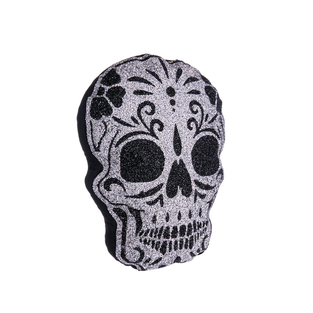 Dazzle your home with this spook-tacular sugar skull pillow! This shimmering pillow will liven up your Halloween or Dia de Los Muertos decor. With black and silver rhinestones on a velvet cover. Material: Cover - Velvet with Resin Rhinestones, Polyester Fill Dimensions: 10" x 16" Note: Not recommended for children.