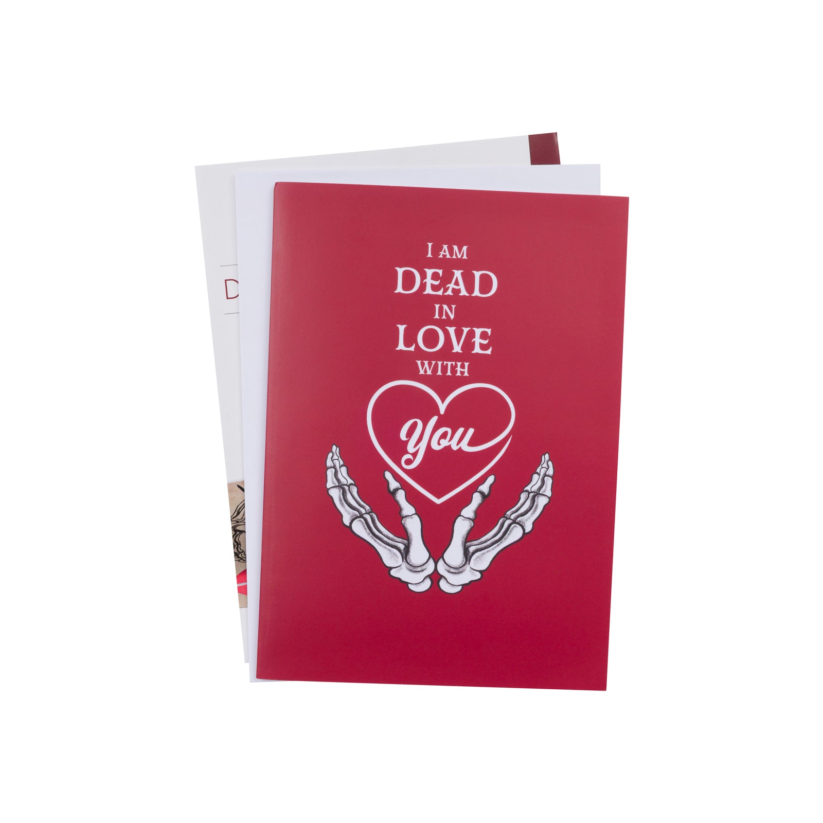 A 3D pop-up greeting card with a red background showing a skeleton couple and the text 'I am DEAD in love with you'. The card is partially opened to reveal the pop-up design.