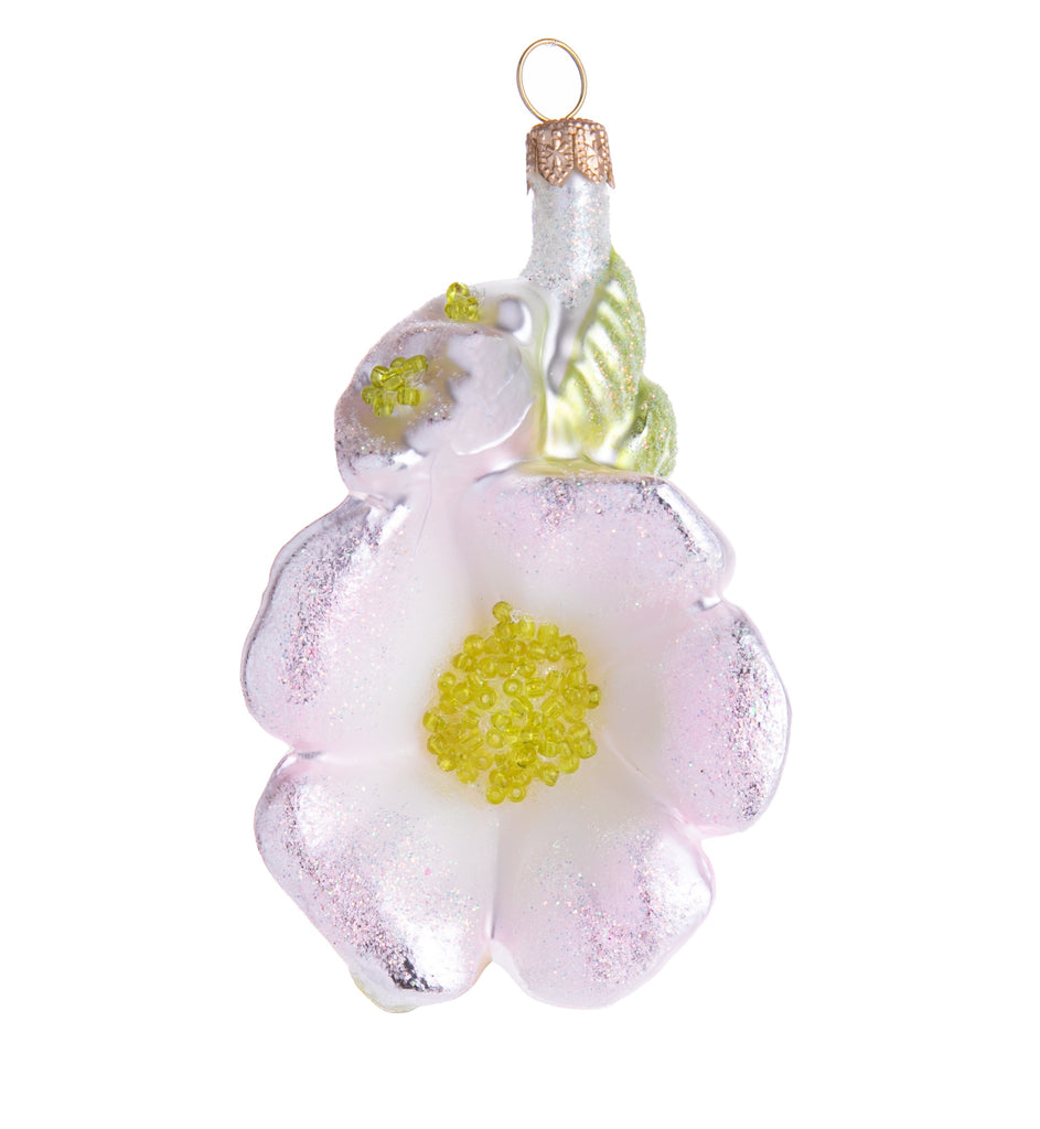 This sparkling glass ornament depicts a fresh spring blossom in a beautiful soft-pink hue, hand finished with fine iridescent glitter.