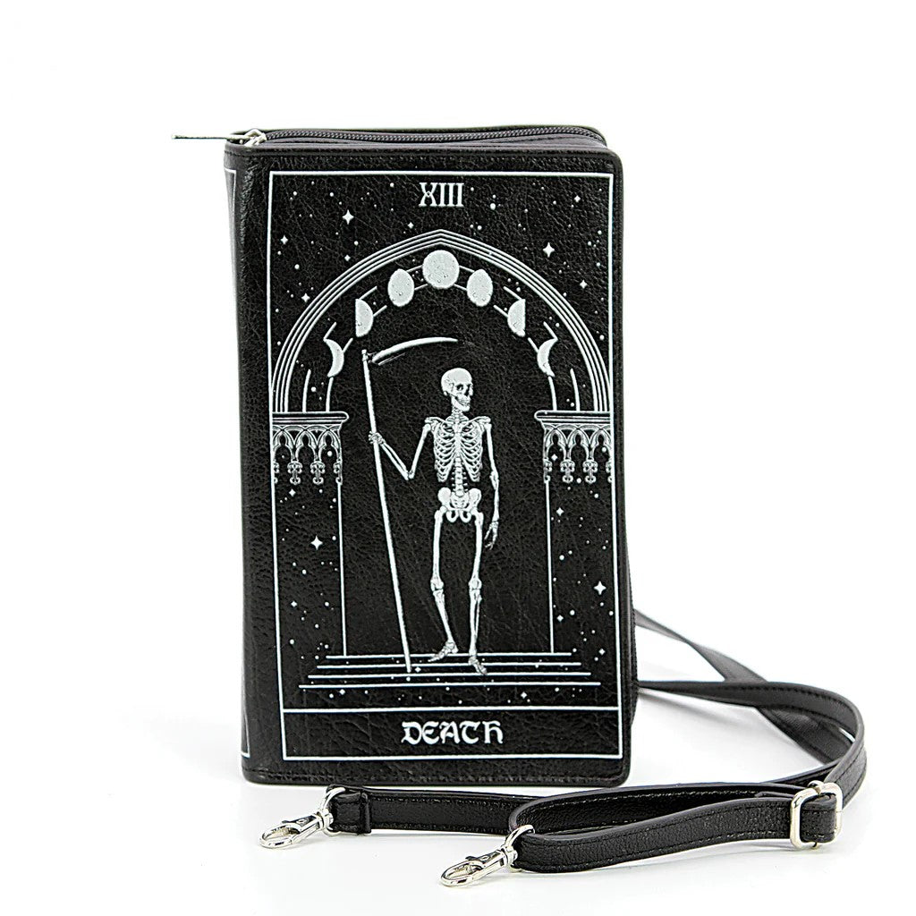 This tarot card purse features a zippered closure, a zippered compartment inside that divides two sections, as well as a shoulder strap and a wristlet strap for a clutch. With the Moon tarot card on one side and the Death card on the other. Dimensions: 6" x 2.5"x 9.5" Material: Vinyl Detachable wrist strap