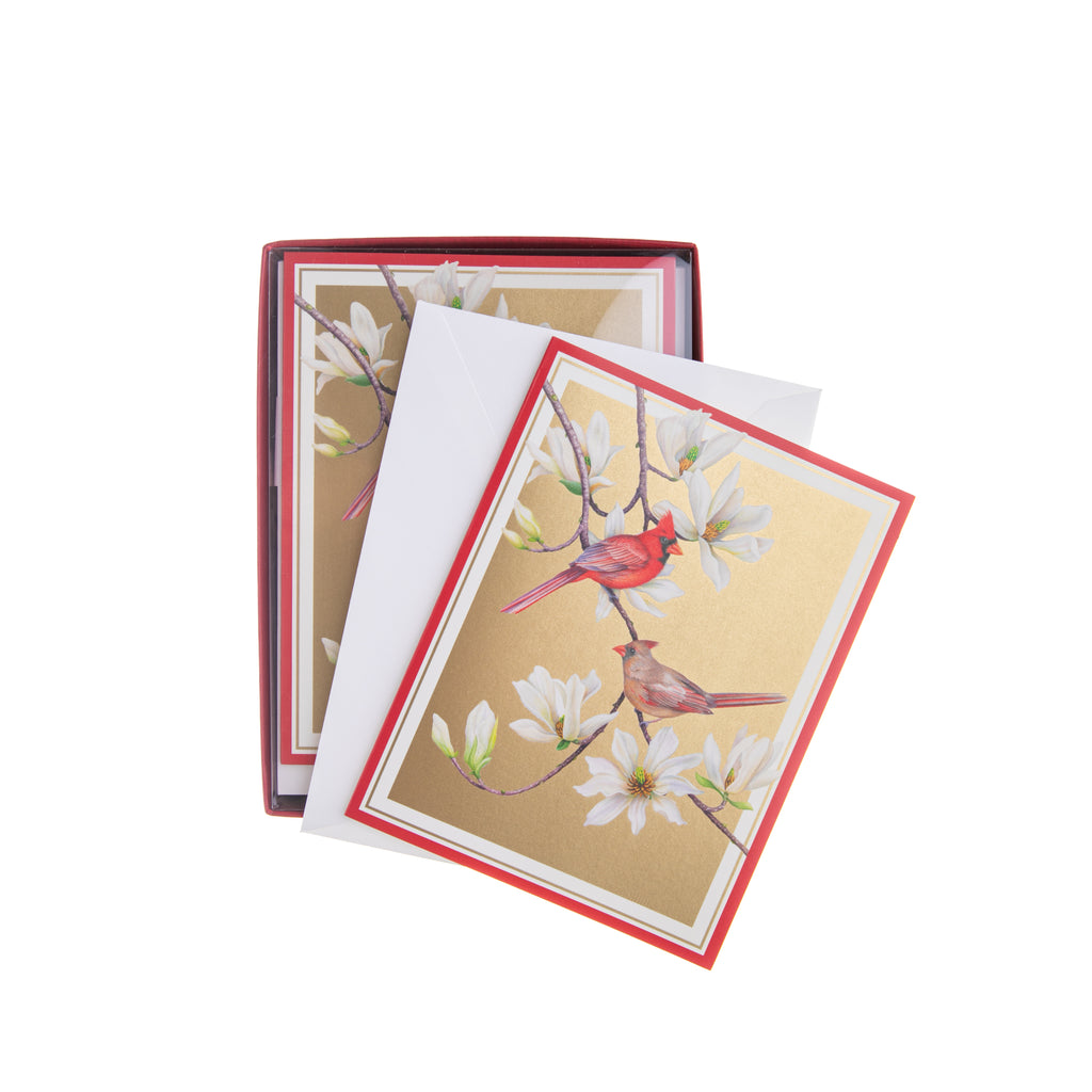 Send your loved ones your best wishes for the new year with these boxed holiday notecards. Featuring cardinals and magnolias, these boxed notecards have a gold background. Inside the card is the message "Season's Greetings and best wishes for the New Year". Dimensions: 5" x 6.75" Boxed set of 15 cards and 16 envelopes