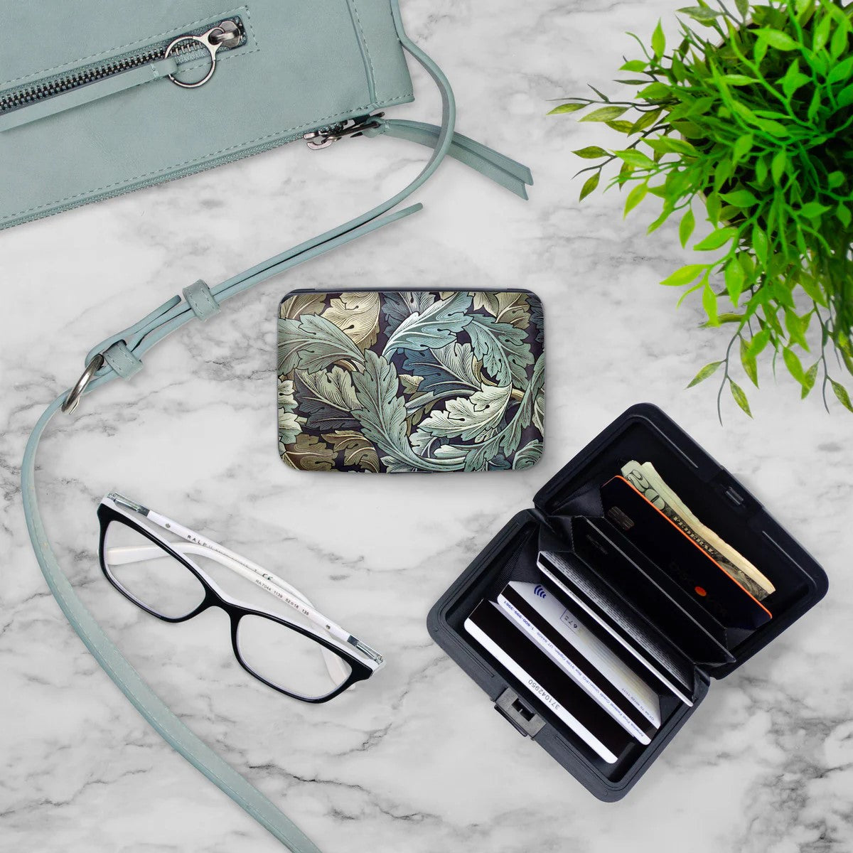 Celebrate William Morris with this armored wallet decorated with William Morris' Acanthus. Made of aluminum, this wallet offers a tear resistant fabric interior accordion. The RFID blocking technology will protect against identity theft. Dimensions: 4" x 3" x 0.75" 6 pocket divider 
