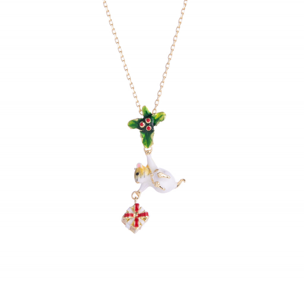 This holiday pendant necklace features a mouse clutching a present underneath a sprig of holly. The enamel is hand-painted, and the gold-plated detail brings glam to this charming necklace. Material: Gold-plated Brass, Enamel Dimensions: Approx. 16" Chain plus 2" extender, Pendant - 0.6" W x 1.2" L Lobster claw closure