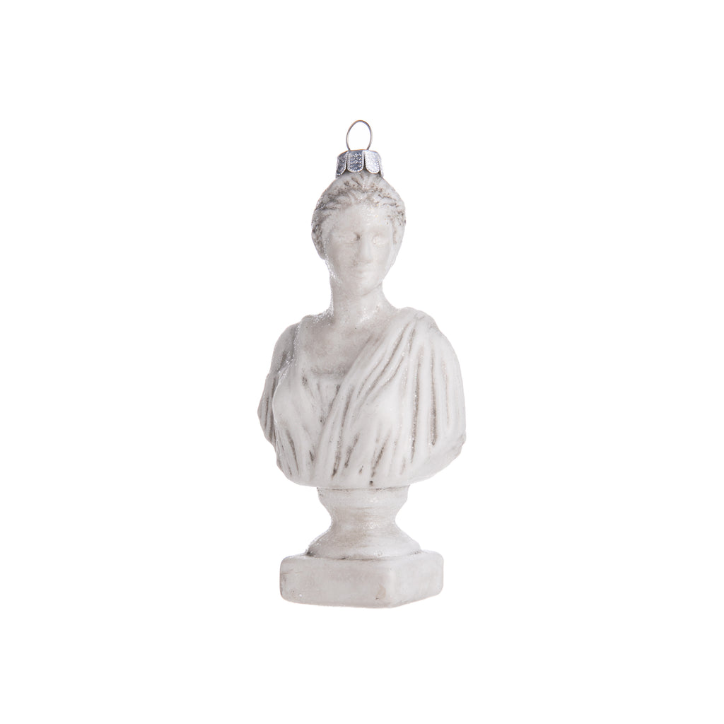 Celebrate the classics with this ornament based on Diana, the Roman goddess. This glass ornament inspired by Roman statues features the bust of Diana, who was the goddess of nature, the hunt, and the moon. Hand-decorated with glitter, introduce her regal spirit into your home and holiday decor. Dimensions: 5" height 