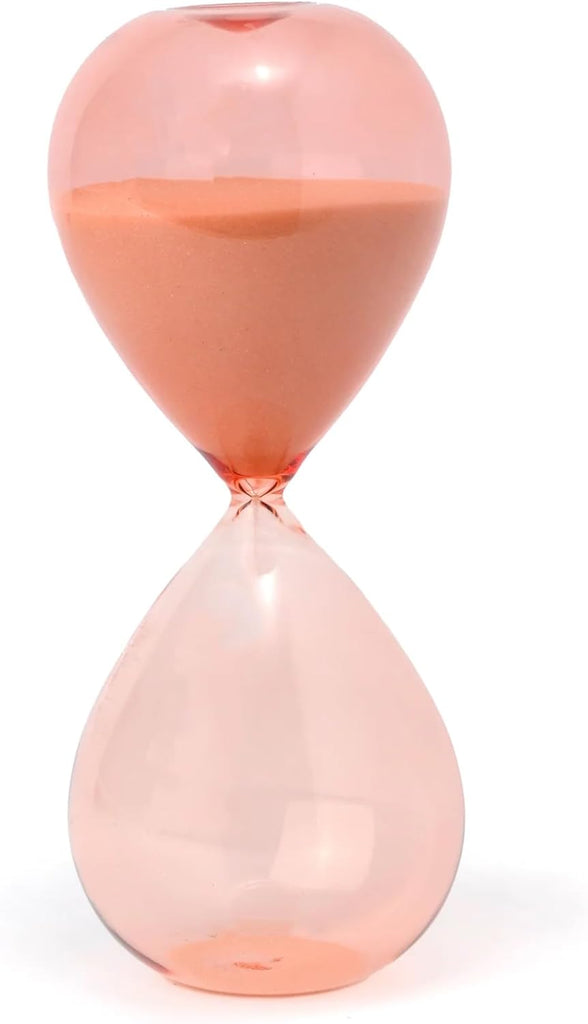 This peach-colored hourglass is timed for 30 minutes and for any place you need to set a timer and get some focus. With ombré tinted glass and peachy-coral colored sand, this hourglass is modern and pretty to stick anywhere in your home or office. Dimensions: 7.8" tall 30 minute timer