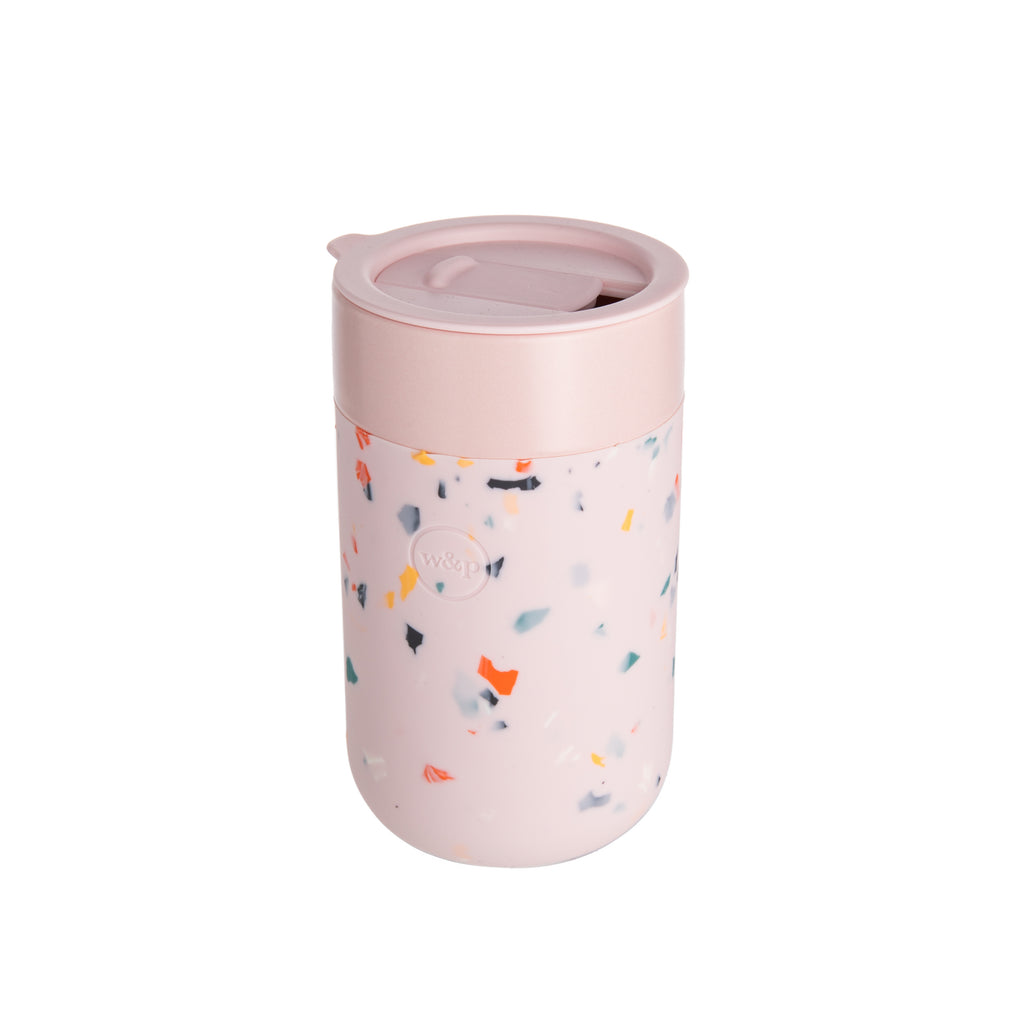 This ceramic travel mug is for enjoying a drink on the go. It offers a stylish alternative to stainless-steel containers and comes in two colors. The splash-resistant lid helps prevent spills, while the silicone sleeve ensures a secure grip. Capacity: 16 oz. Materials: ceramic mug, silicone sleeve BPA free, sustainable