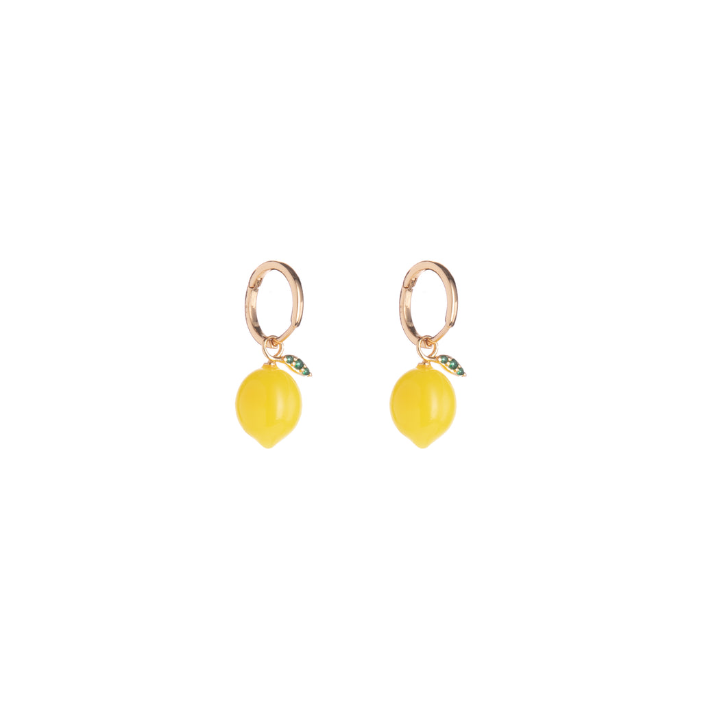 Zest up your jewelry collection with these lemon drop huggie earrings! With a refreshing resin lemon and CZ green enamel leaves, these lemon drops will add subtle yet eye-catching citrus to any outfit.  Material: Brass, Resin, CZ Dimensions: Approx. 1" Length, 0.3" Width Huggie hoop closure Lead and Nickel-free