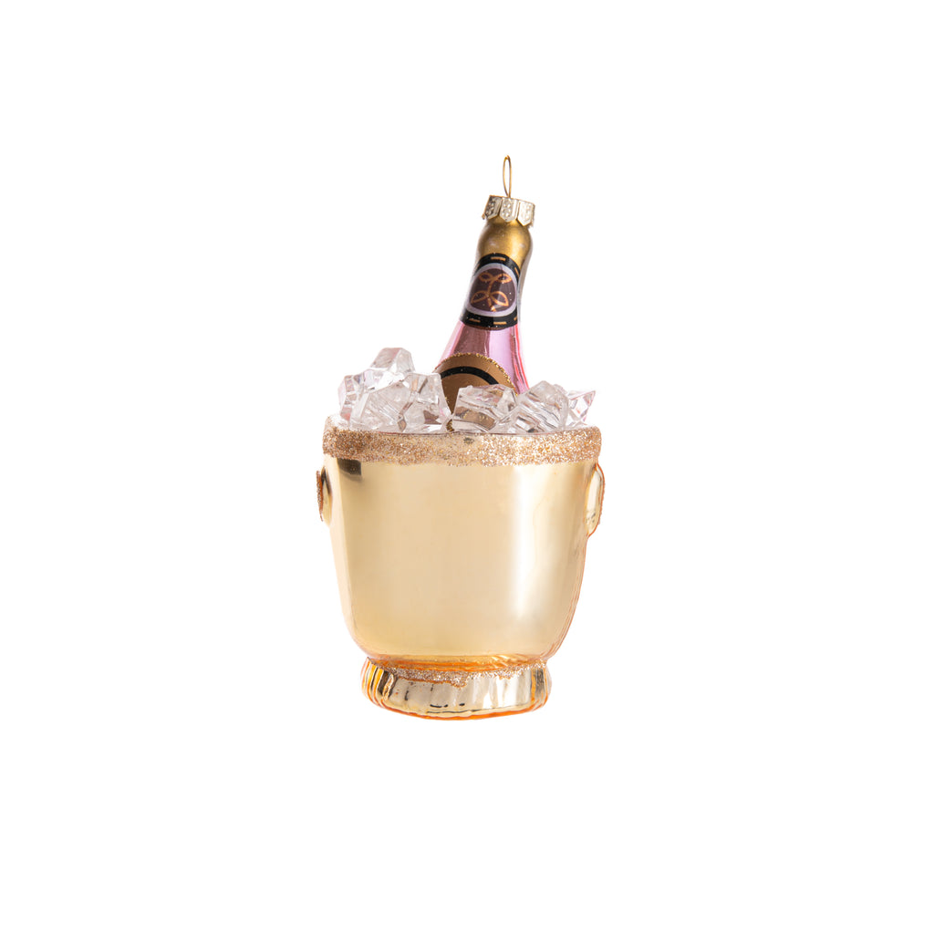 Toast to life with this champagne bucket ornament! Hand-decorated with a pink and gold finish, glitter, and ice cubes, this champagne bucket is an elegant addition to your holiday and home decor. Whether hung on the tree or on a tablescape, this ornament is perfect for celebrating. Dimensions: 4.25" H 