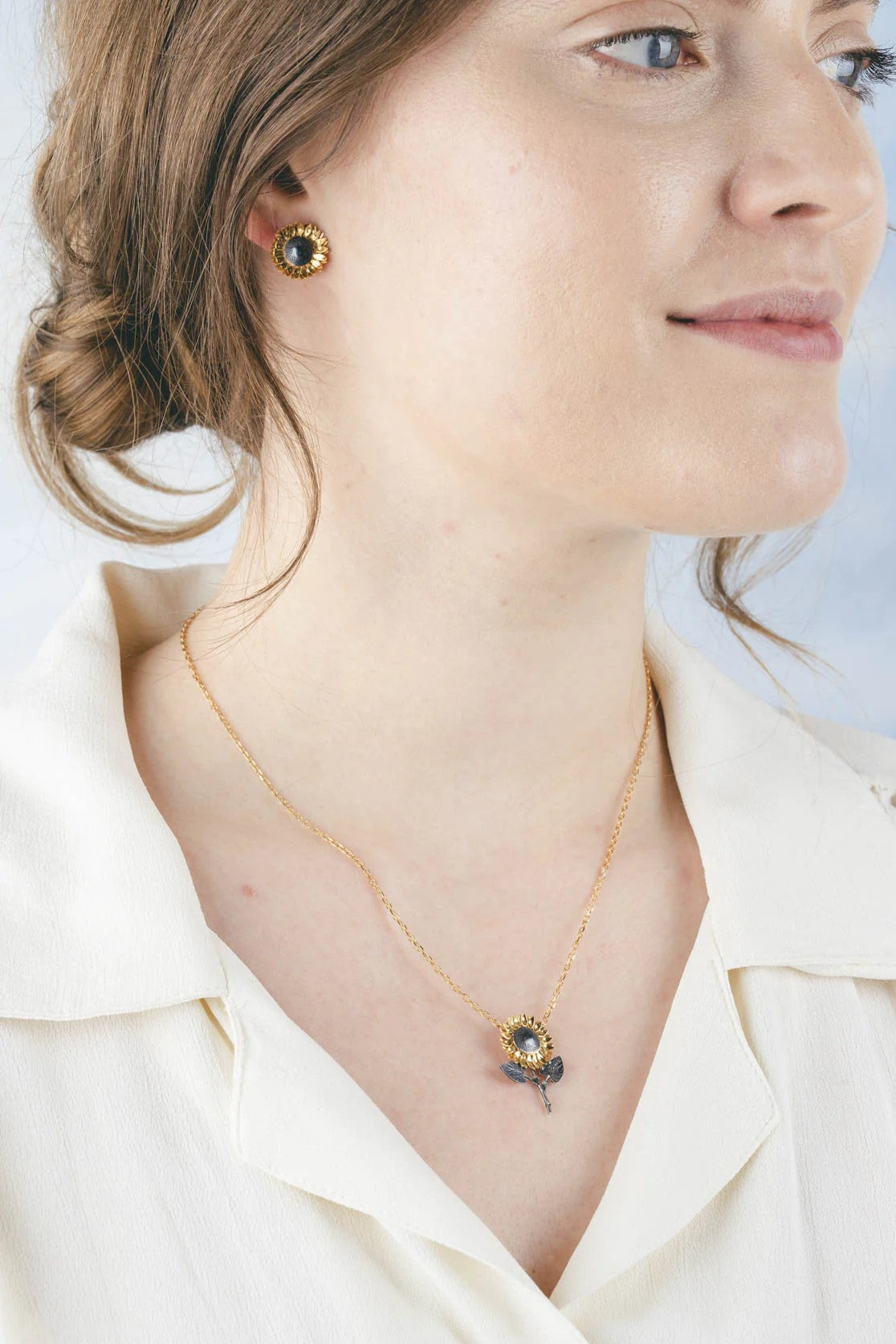 Wear and spread joy with this sunflower stalk necklace. With gold detail for the petals, the rest of the pendant is oxidized silver to make the yellow stand out and shine like a real sunflower.