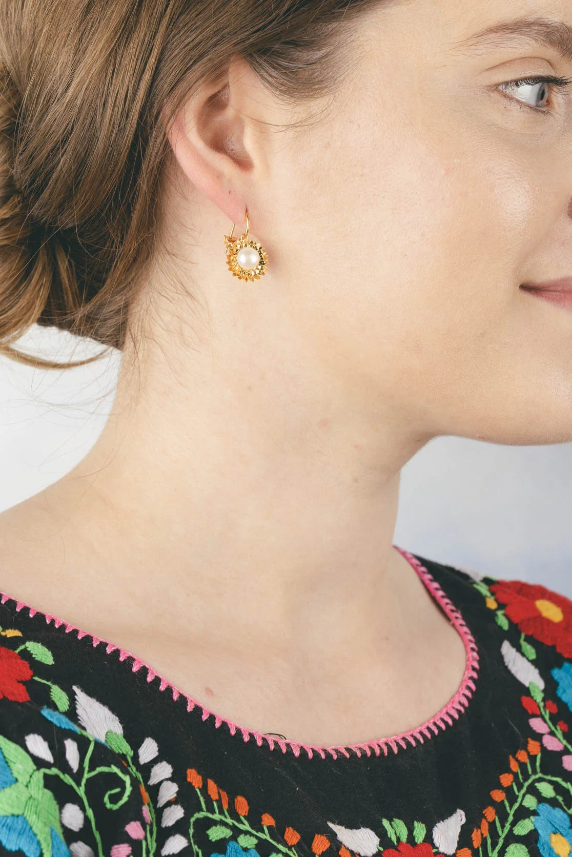 With gold detail and a freshwater pearl in the center, these sunflower pearl hoop earrings will help you to shine like a real sunflower. 