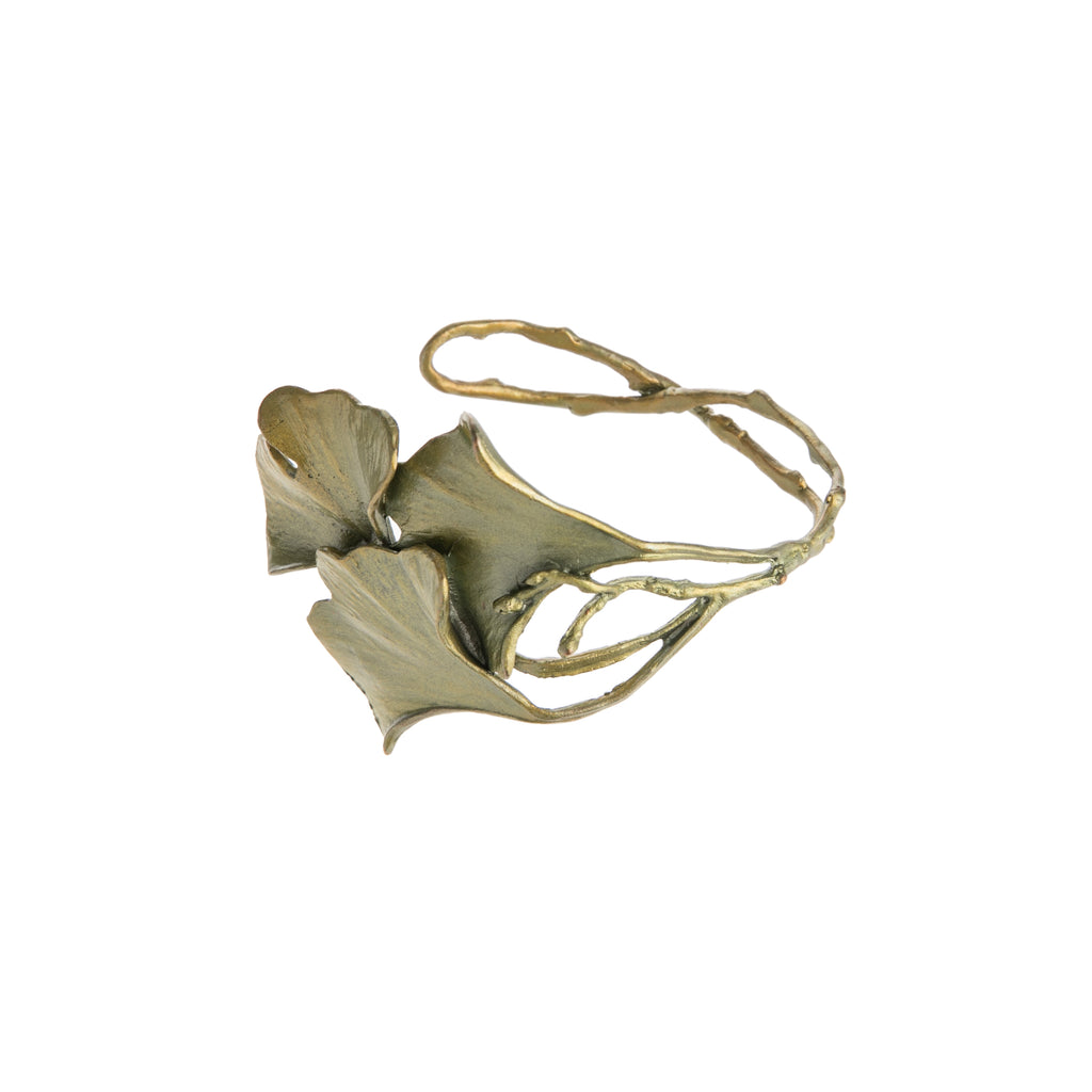 This cuff featuring three ginkgo leaves is cast in hand patinated bronze. The leaf has a greenish tone with yellow and bronze, as if the leaf is changing color.