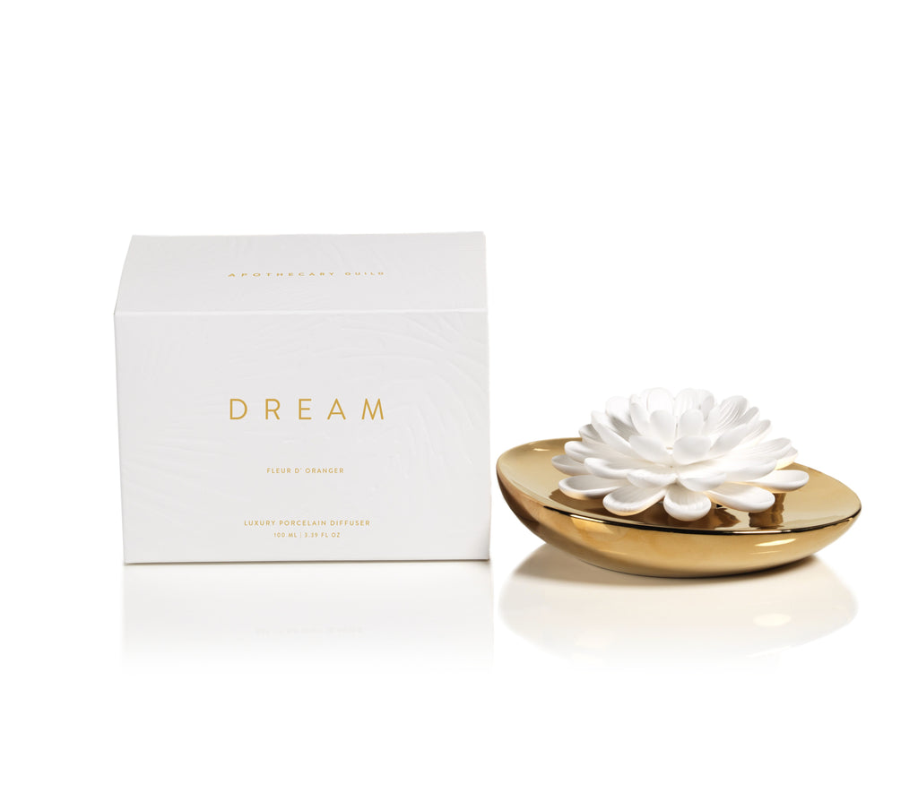 Elegant and eye-catching, this lovely porcelain diffuser is a subtle way to add all-day fragrance to a room. A gorgeous gold-tone container holds a porcelain flower that wicks and diffuses an alluring scent. No reeds required. Oil volume: 3.4 oz. Measures 7" x 5.5" x 3" Box dimensions: 7.25" x 7.25" x 5.25"