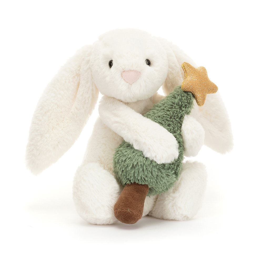 Bashful Bunny with Christmas Tree has the softest white fur, snuggly ears and a silky bobtail, as well as a pink suedette nose. They've brought home their very own evergreen tree with a gold jersey star just in time for Christmas! Dimensions: 7.1" x 3.5" x 3.1" Material: Polyester, PE Beans Suitable from birth