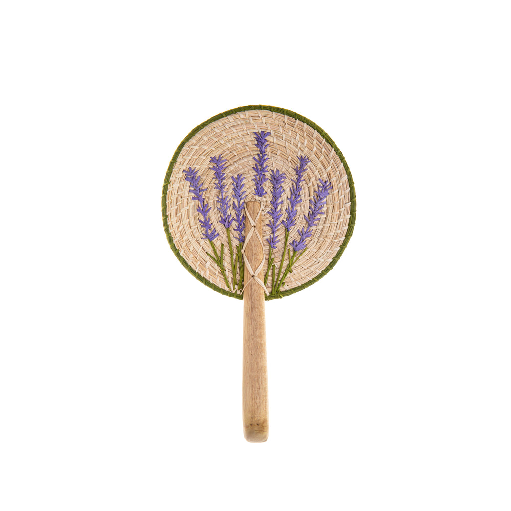 This paddle-style fan was woven and embroidered by hand in Columbia. Both the fan and the embroidered details are made from dried iraca palm leaves.