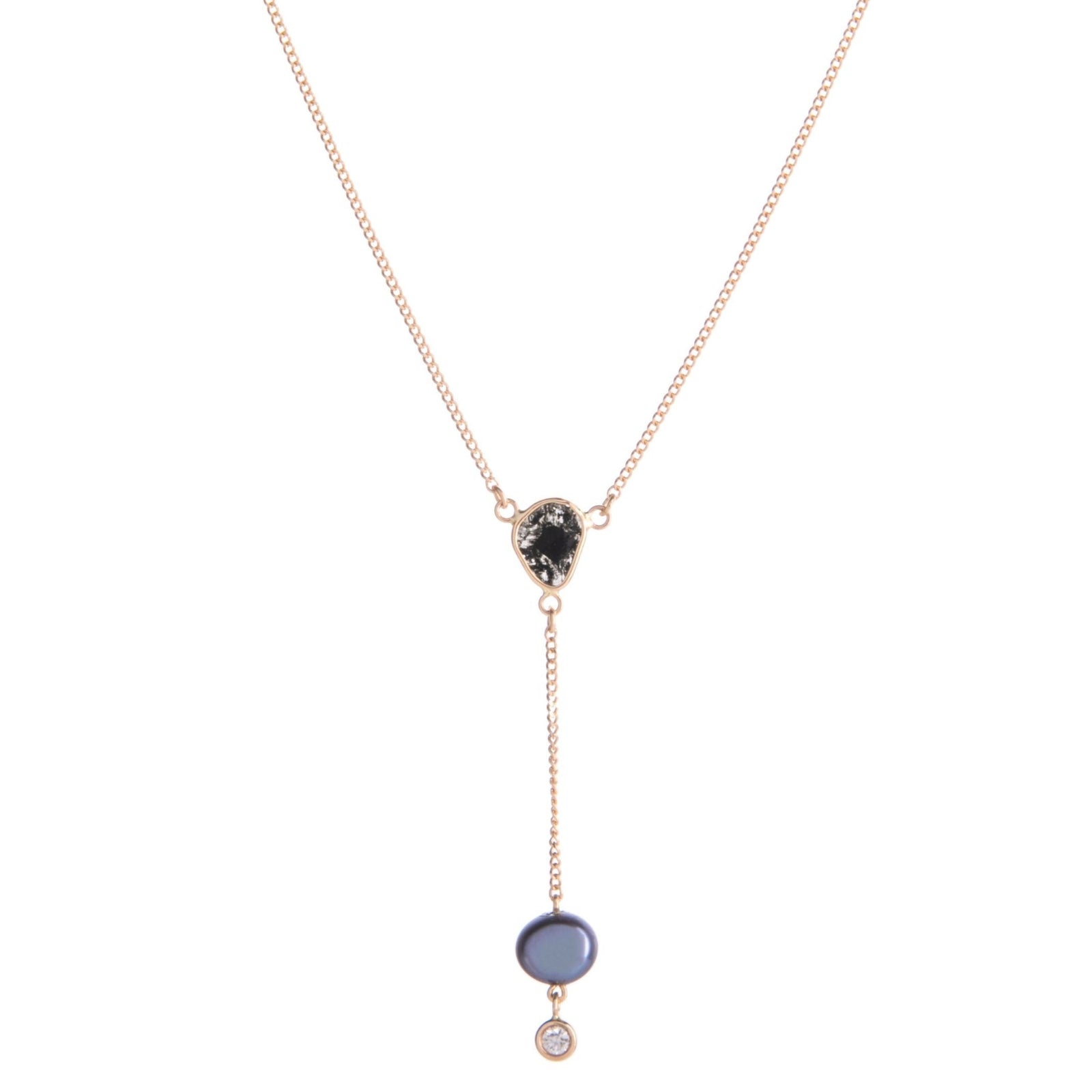 Subtlety meets glamour in this understated but very elegant lariat necklace. Featuring a freshwater peacock pearl at the bottom with a tiny white diamond, this lariat necklace also boasts a very unique black diamond slice situated just above. On a delicate 14k gold chain.
