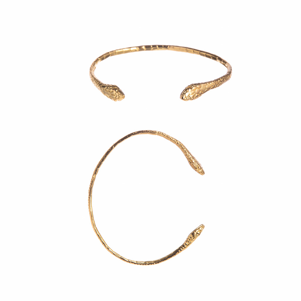 Slither your way into glamour with this elegant gold snake bracelet. With two heads of a snake that wrap around your wrist and delicate snake scale detail.