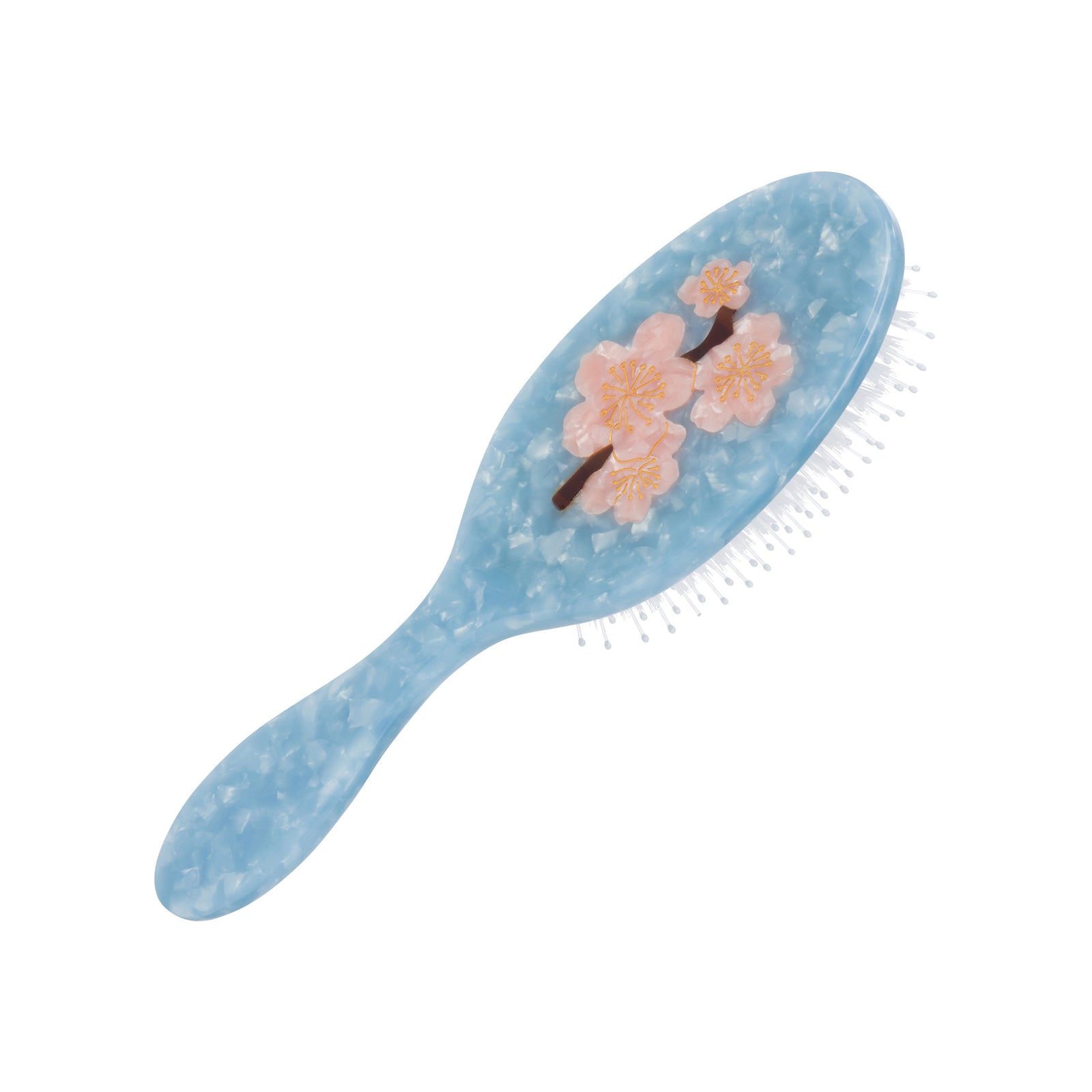 Hairbrush with floral design on a blue and white background