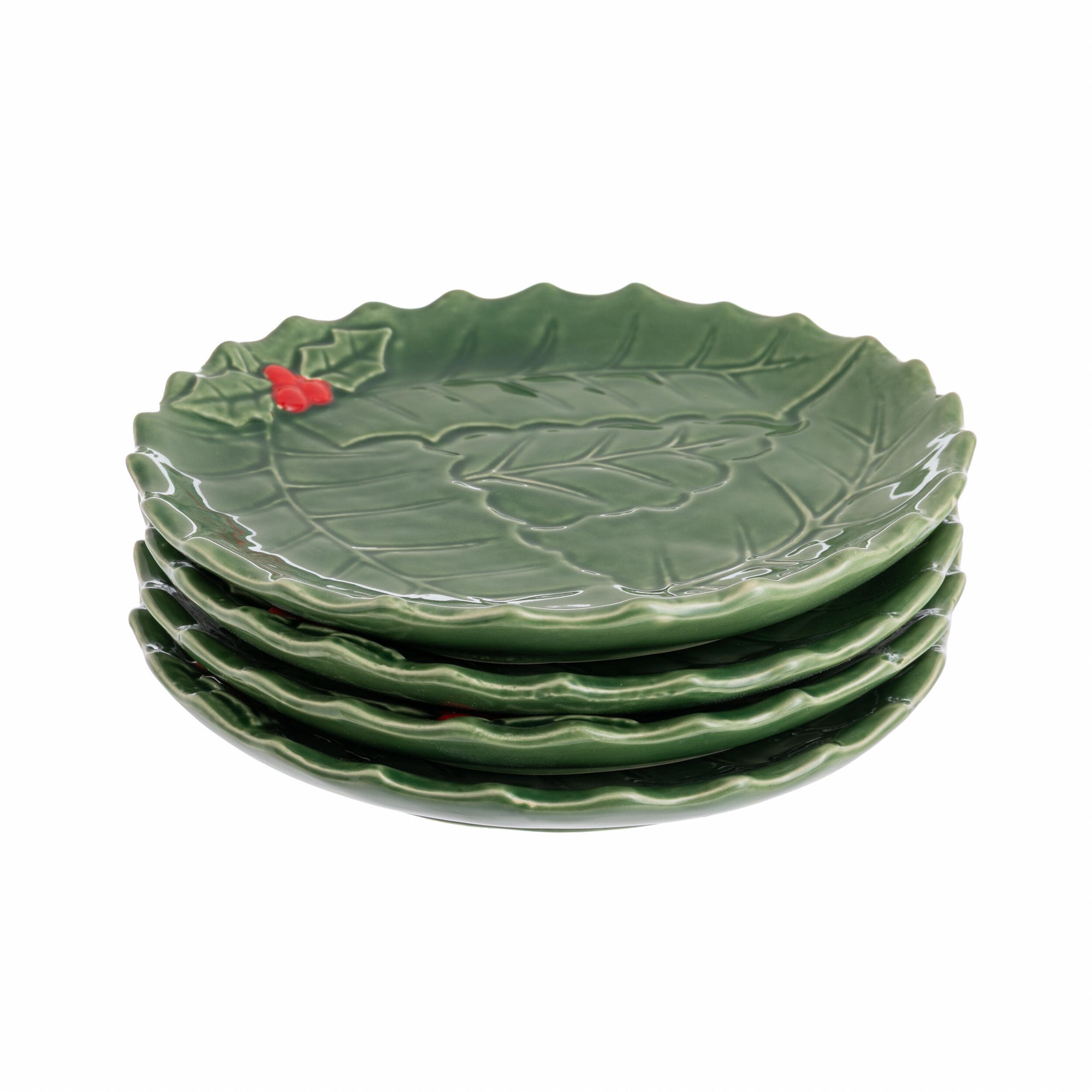 Green ceramic plate with green holly and red berry design on a white background